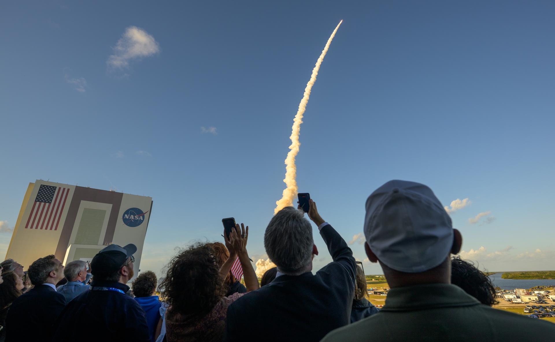 Guests watch the launch of NASA’s Space Launch System rocket carrying the Orion spacecraft with NASA astronauts Reid Wiseman, commander; Victor Glover, pilot; Christina Koch, mission specialist; and CSA (Canadian Space Agency) astronaut Jeremy Hansen, mission specialist on NASA’s Artemis II mission,, Wednesday, April 1, 2026, from Operations and Support Building II at NASA’s Kennedy Space Center in Florida. NASA’s Artemis II mission will take Wiseman, Glover, Koch, and Hansen on a 10-day journey around the Moon and back aboard SLS rocket and Orion spacecraft launched at 6:35pm EDT, from Launch Complex 39B. Photo Credit: (NASA/Bill Ingalls)