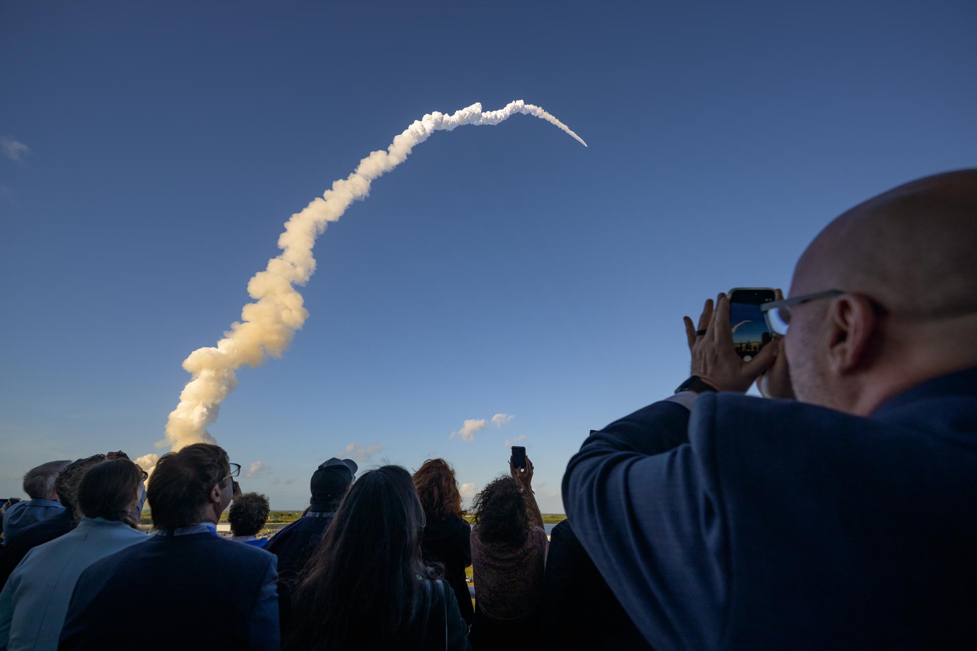 Guests watch the launch of NASA’s Space Launch System rocket carrying the Orion spacecraft with NASA astronauts Reid Wiseman, commander; Victor Glover, pilot; Christina Koch, mission specialist; and CSA (Canadian Space Agency) astronaut Jeremy Hansen, mission specialist on NASA’s Artemis II mission,, Wednesday, April 1, 2026, from Operations and Support Building II at NASA’s Kennedy Space Center in Florida. NASA’s Artemis II mission will take Wiseman, Glover, Koch, and Hansen on a 10-day journey around the Moon and back aboard SLS rocket and Orion spacecraft launched at 6:35pm EDT, from Launch Complex 39B. Photo Credit: (NASA/Bill Ingalls)