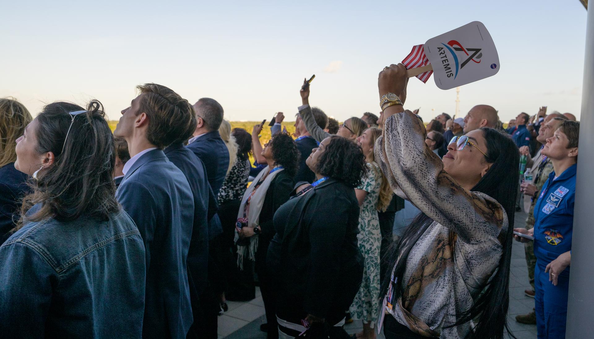 Guests watch the launch of NASA’s Space Launch System rocket carrying the Orion spacecraft with NASA astronauts Reid Wiseman, commander; Victor Glover, pilot; Christina Koch, mission specialist; and CSA (Canadian Space Agency) astronaut Jeremy Hansen, mission specialist on NASA’s Artemis II mission,, Wednesday, April 1, 2026, from Operations and Support Building II at NASA’s Kennedy Space Center in Florida. NASA’s Artemis II mission will take Wiseman, Glover, Koch, and Hansen on a 10-day journey around the Moon and back aboard SLS rocket and Orion spacecraft launched at 6:35pm EDT, from Launch Complex 39B. Photo Credit: (NASA/Bill Ingalls)
