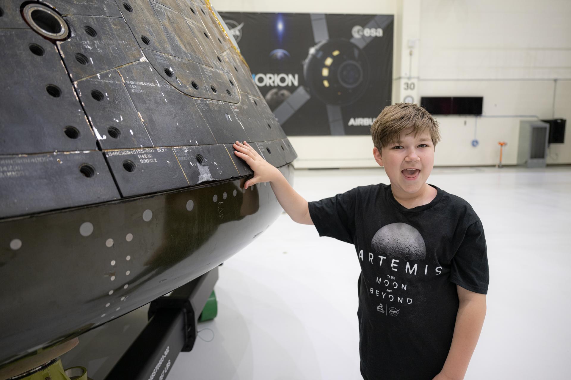 Eleven-year-old Hilt Boling visits the Artemis I Orion spacecraft at the Neil A. Armstrong Operations and Checkout Building, Friday, Apr. 3, 2026, at NASA’s Kennedy Space Center in Florida. When asked during an April 1 television appearance why he loved space and being at the Artemis II launch, Boling exclaimed: “We’re going back to the freaking Moon, that’s why!” His comments received widespread social media attention in the following days. Photo Credit: (NASA/John Kraus)