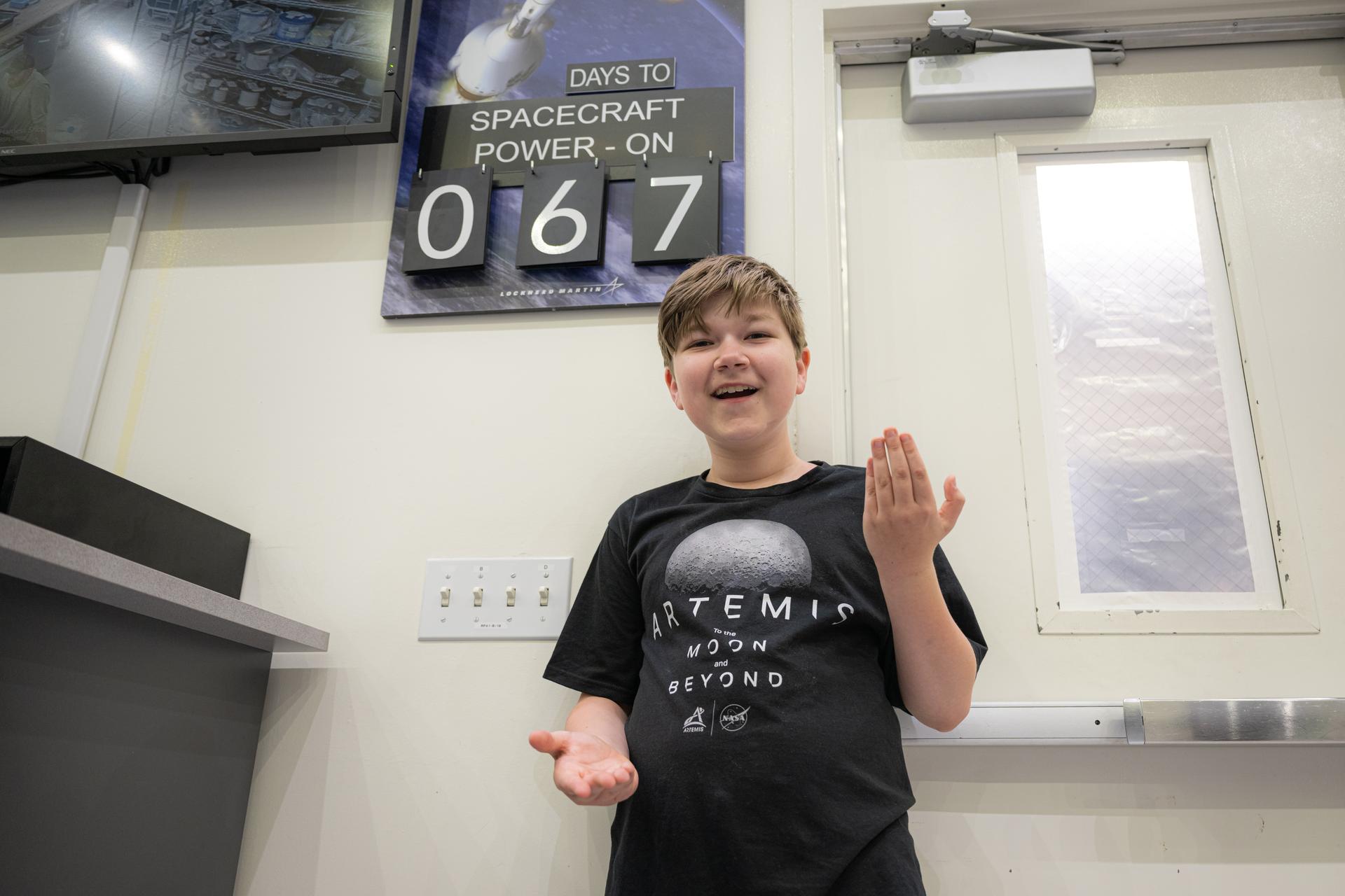 Eleven-year-old Hilt Boling poses for a photograph in the Neil A. Armstrong Operations and Checkout Building, Friday, Apr. 3, 2026, at NASA’s Kennedy Space Center in Florida. When asked during an April 1 television appearance why he loved space and being at the Artemis II launch, Boling exclaimed: “We’re going back to the freaking Moon, that’s why!” His comments received widespread social media attention in the following days. Photo Credit: (NASA/John Kraus)