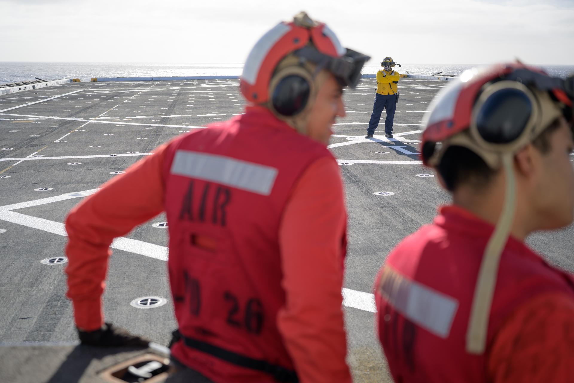 U.S. Navy sailors work the flight deck on USS John P. Murtha (LPD 26) as NASA, U.S. Navy, and U.S. Air Force teams head into the Pacific Ocean for the return of the Artemis II crewmembers to Earth, Monday, April 6, 2026, in the Pacific Ocean off the coast of California. NASA’s Artemis II mission is taking NASA astronauts Reid Wiseman, commander; Victor Glover, pilot; Christina Koch, mission specialist; and CSA (Canadian Space Agency) astronaut Jeremy Hansen, mission specialist on a 10-day journey around the Moon and back aboard their Orion spacecraft. Wiseman, Glover, Koch, and Hansen are scheduled to splash down off the coast of San Diego at approximately 5:07 p.m. PDT (8:07 p.m. EDT) on Friday, April 10.  Photo Credit: (NASA/Bill Ingalls)