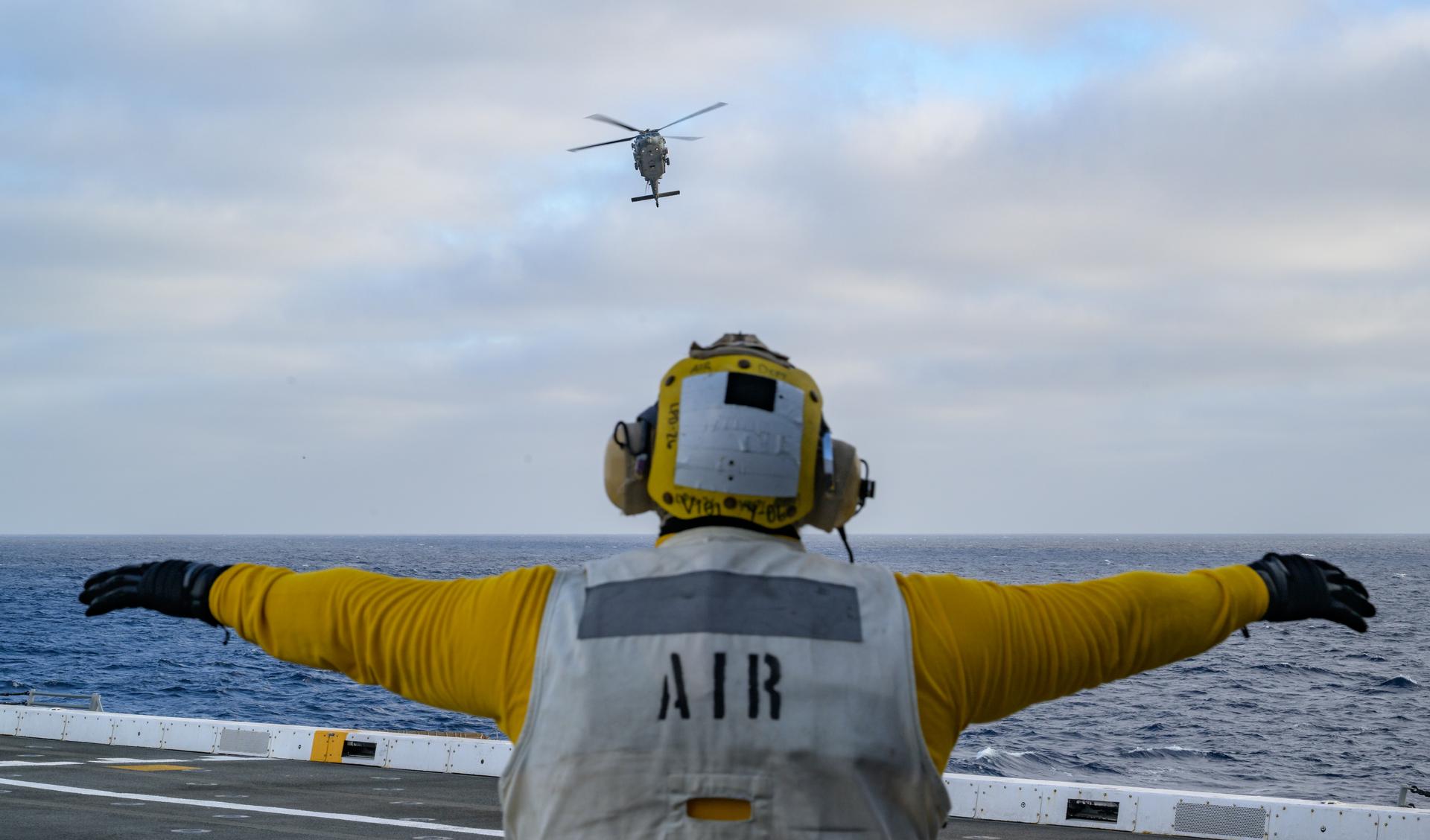 U.S. Navy MH-60 Seahawks from Helicopter Sea Combat Squadron (HSC) 23 are seen arriving on the flight deck of USS John P. Murtha as they prepare to conduct air operations training as NASA, U.S. Navy, and U.S. Air Force teams prepare for the the return of the Artemis II crewmembers to Earth, Monday, April 6, 2026, in the Pacific Ocean off the coast of California. NASA’s Artemis II mission is taking NASA astronauts Reid Wiseman, commander; Victor Glover, pilot; Christina Koch, mission specialist; and CSA (Canadian Space Agency) astronaut Jeremy Hansen, mission specialist on a 10-day journey around the Moon and back aboard their Orion spacecraft. Wiseman, Glover, Koch, and Hansen are scheduled to splash down off the coast of San Diego at approximately 5:07 p.m. PDT (8:07 p.m. EDT) on Friday, April 10.  Photo Credit: (NASA/Bill Ingalls)