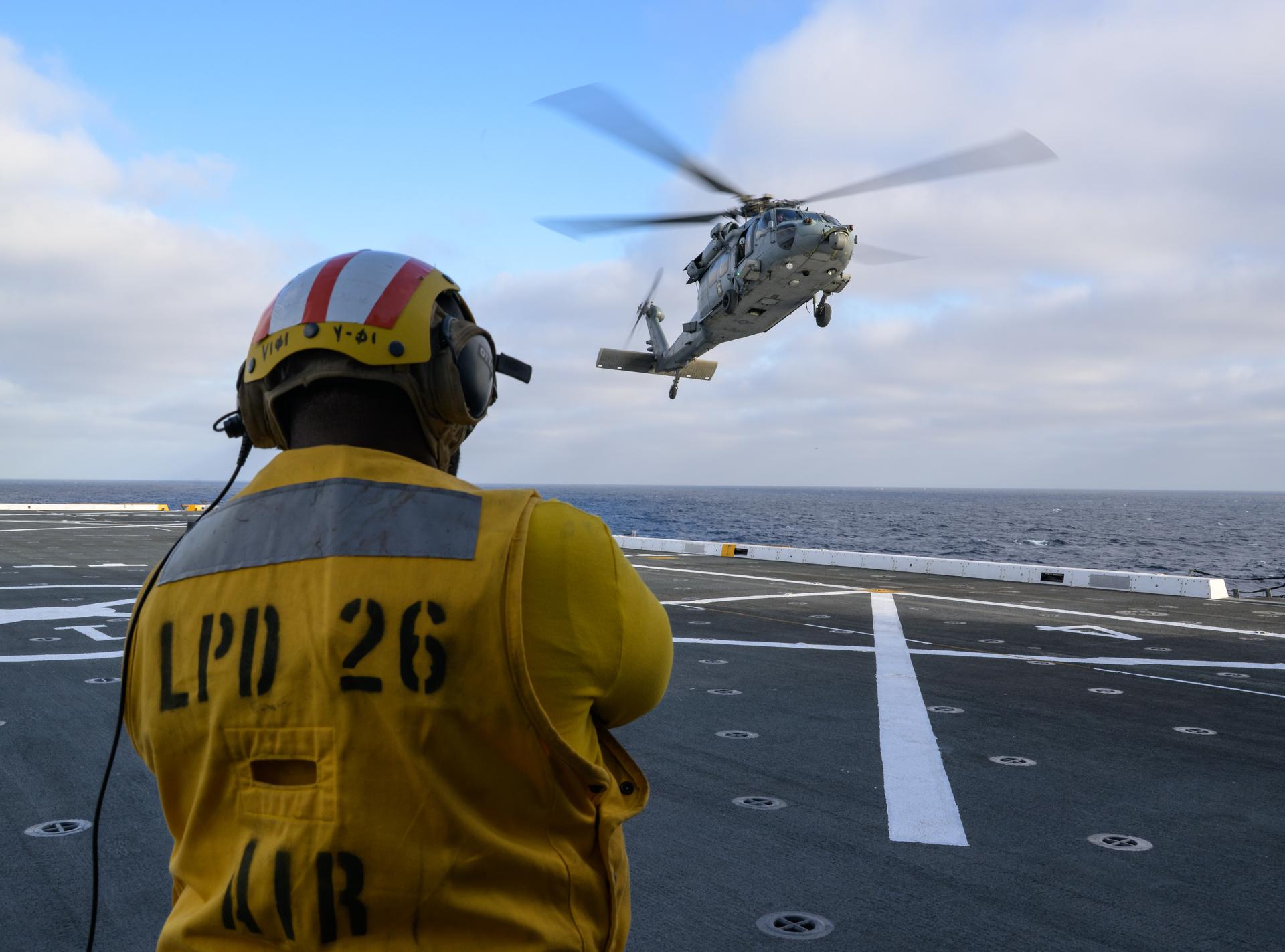U.S. Navy MH-60 Seahawks from Helicopter Sea Combat Squadron (HSC) 23 are seen arriving on the flight deck of USS John P. Murtha as they prepare to conduct air operations training as NASA, U.S. Navy, and U.S. Air Force teams prepare for the the return of the Artemis II crewmembers to Earth, Monday, April 6, 2026, in the Pacific Ocean off the coast of California. NASA’s Artemis II mission is taking NASA astronauts Reid Wiseman, commander; Victor Glover, pilot; Christina Koch, mission specialist; and CSA (Canadian Space Agency) astronaut Jeremy Hansen, mission specialist on a 10-day journey around the Moon and back aboard their Orion spacecraft. Wiseman, Glover, Koch, and Hansen are scheduled to splash down off the coast of San Diego at approximately 5:07 p.m. PDT (8:07 p.m. EDT) on Friday, April 10.  Photo Credit: (NASA/Bill Ingalls)