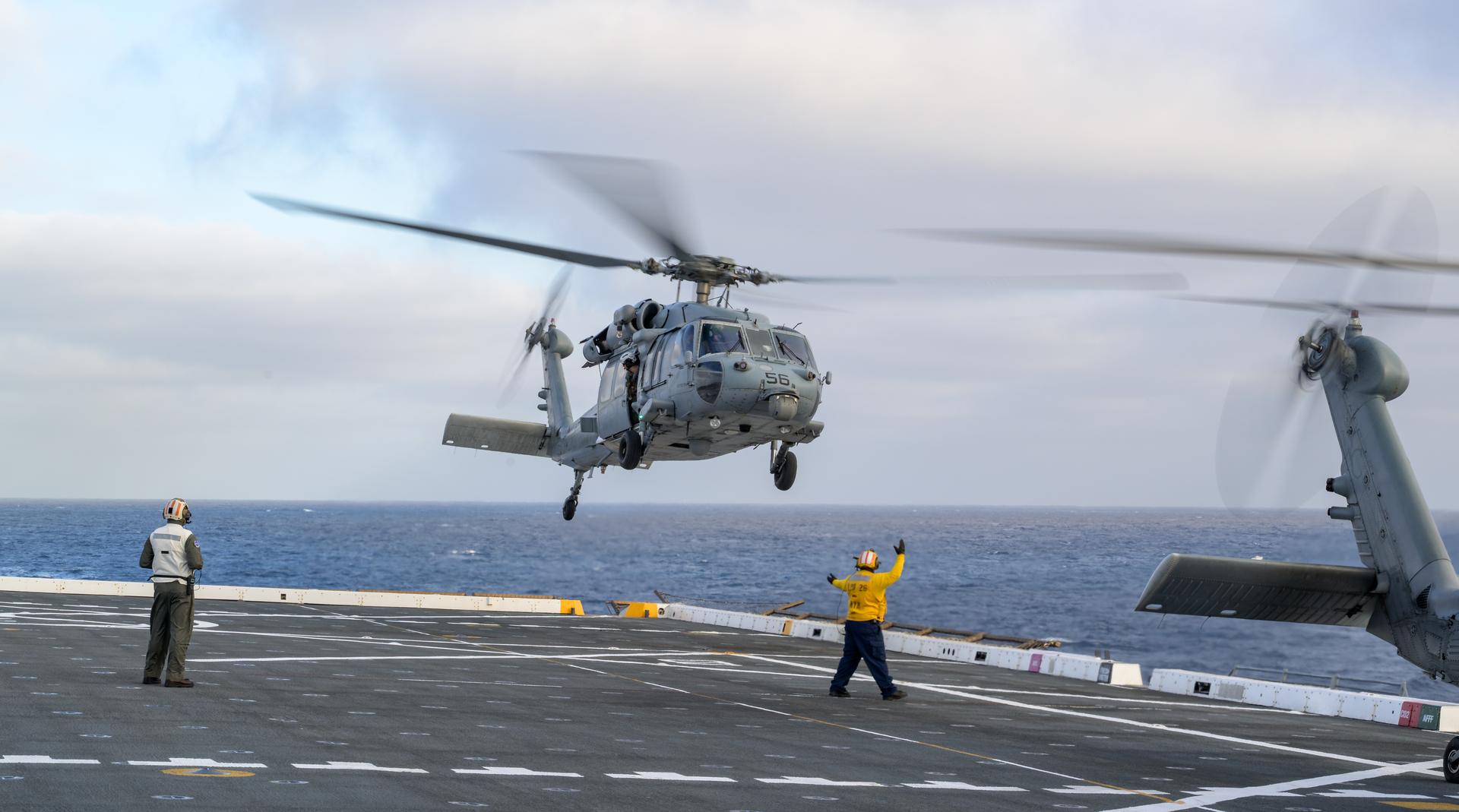U.S. Navy MH-60 Seahawks from Helicopter Sea Combat Squadron (HSC) 23 are seen arriving on the flight deck of USS John P. Murtha as they prepare to conduct air operations training as NASA, U.S. Navy, and U.S. Air Force teams prepare for the the return of the Artemis II crewmembers to Earth, Monday, April 6, 2026, in the Pacific Ocean off the coast of California. NASA’s Artemis II mission is taking NASA astronauts Reid Wiseman, commander; Victor Glover, pilot; Christina Koch, mission specialist; and CSA (Canadian Space Agency) astronaut Jeremy Hansen, mission specialist on a 10-day journey around the Moon and back aboard their Orion spacecraft. Wiseman, Glover, Koch, and Hansen are scheduled to splash down off the coast of San Diego at approximately 5:07 p.m. PDT (8:07 p.m. EDT) on Friday, April 10.  Photo Credit: (NASA/Bill Ingalls)