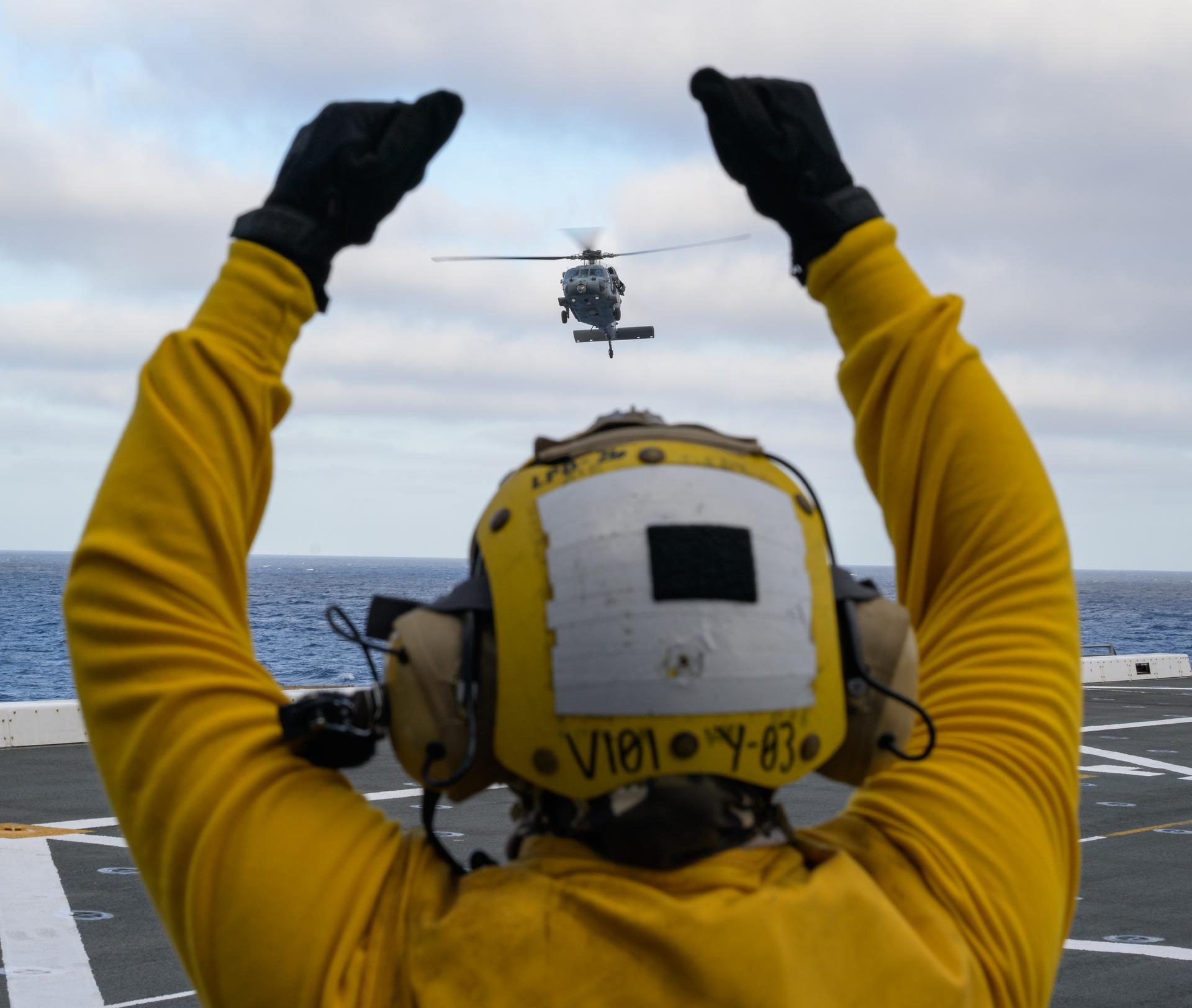 U.S. Navy MH-60 Seahawks from Helicopter Sea Combat Squadron (HSC) 23 are seen arriving on the flight deck of USS John P. Murtha as they prepare to conduct air operations training as NASA, U.S. Navy, and U.S. Air Force teams prepare for the the return of the Artemis II crewmembers to Earth, Monday, April 6, 2026, in the Pacific Ocean off the coast of California. NASA’s Artemis II mission is taking NASA astronauts Reid Wiseman, commander; Victor Glover, pilot; Christina Koch, mission specialist; and CSA (Canadian Space Agency) astronaut Jeremy Hansen, mission specialist on a 10-day journey around the Moon and back aboard their Orion spacecraft. Wiseman, Glover, Koch, and Hansen are scheduled to splash down off the coast of San Diego at approximately 5:07 p.m. PDT (8:07 p.m. EDT) on Friday, April 10.  Photo Credit: (NASA/Bill Ingalls)