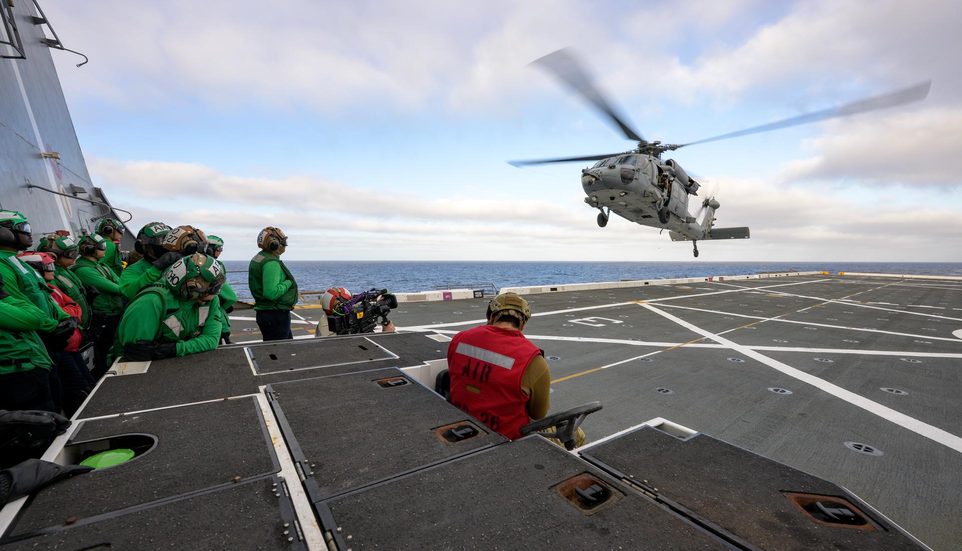 U.S. Navy MH-60 Seahawks from Helicopter Sea Combat Squadron (HSC) 23 are seen arriving on the flight deck of USS John P. Murtha as they prepare to conduct air operations training as NASA, U.S. Navy, and U.S. Air Force teams prepare for the the return of the Artemis II crewmembers to Earth, Monday, April 6, 2026, in the Pacific Ocean off the coast of California. NASA’s Artemis II mission is taking NASA astronauts Reid Wiseman, commander; Victor Glover, pilot; Christina Koch, mission specialist; and CSA (Canadian Space Agency) astronaut Jeremy Hansen, mission specialist on a 10-day journey around the Moon and back aboard their Orion spacecraft. Wiseman, Glover, Koch, and Hansen are scheduled to splash down off the coast of San Diego at approximately 5:07 p.m. PDT (8:07 p.m. EDT) on Friday, April 10.  Photo Credit: (NASA/Bill Ingalls)