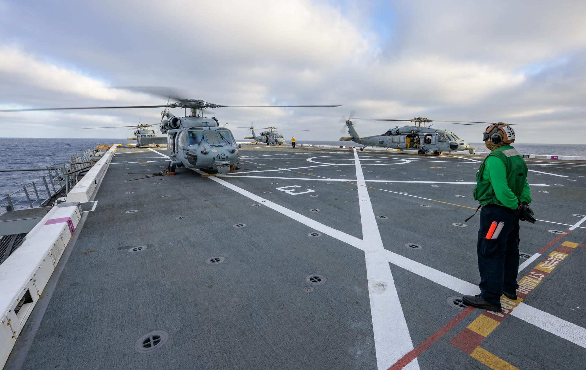 U.S. Navy MH-60 Seahawks from Helicopter Sea Combat Squadron (HSC) 23 are seen after arriving on the flight deck of USS John P. Murtha as they prepare to conduct air operations training as NASA, U.S. Navy, and U.S. Air Force teams prepare for the the return of the Artemis II crewmembers to Earth, Monday, April 6, 2026, in the Pacific Ocean off the coast of California. NASA’s Artemis II mission is taking NASA astronauts Reid Wiseman, commander; Victor Glover, pilot; Christina Koch, mission specialist; and CSA (Canadian Space Agency) astronaut Jeremy Hansen, mission specialist on a 10-day journey around the Moon and back aboard their Orion spacecraft. Wiseman, Glover, Koch, and Hansen are scheduled to splash down off the coast of San Diego at approximately 5:07 p.m. PDT (8:07 p.m. EDT) on Friday, April 10.  Photo Credit: (NASA/Bill Ingalls)