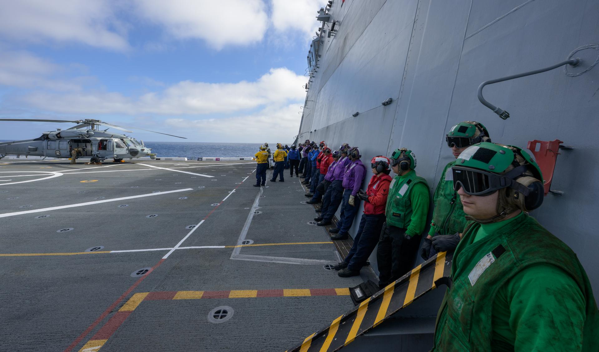U.S. Navy MH-60 Seahawks from Helicopter Sea Combat Squadron (HSC) 23 are seen on the flight deck of USS John P. Murtha as they prepare to takeoff to conduct air operations training as NASA, U.S. Navy, and U.S. Air Force teams prepare for the the return of the Artemis II crewmembers to Earth, Tuesday, April 7, 2026, in the Pacific Ocean off the coast of California. NASA’s Artemis II mission is taking NASA astronauts Reid Wiseman, commander; Victor Glover, pilot; Christina Koch, mission specialist; and CSA (Canadian Space Agency) astronaut Jeremy Hansen, mission specialist on a 10-day journey around the Moon and back aboard their Orion spacecraft. Wiseman, Glover, Koch, and Hansen are scheduled to splash down off the coast of San Diego at approximately 5:07 p.m. PDT (8:07 p.m. EDT) on Friday, April 10.  Photo Credit: (NASA/Bill Ingalls)