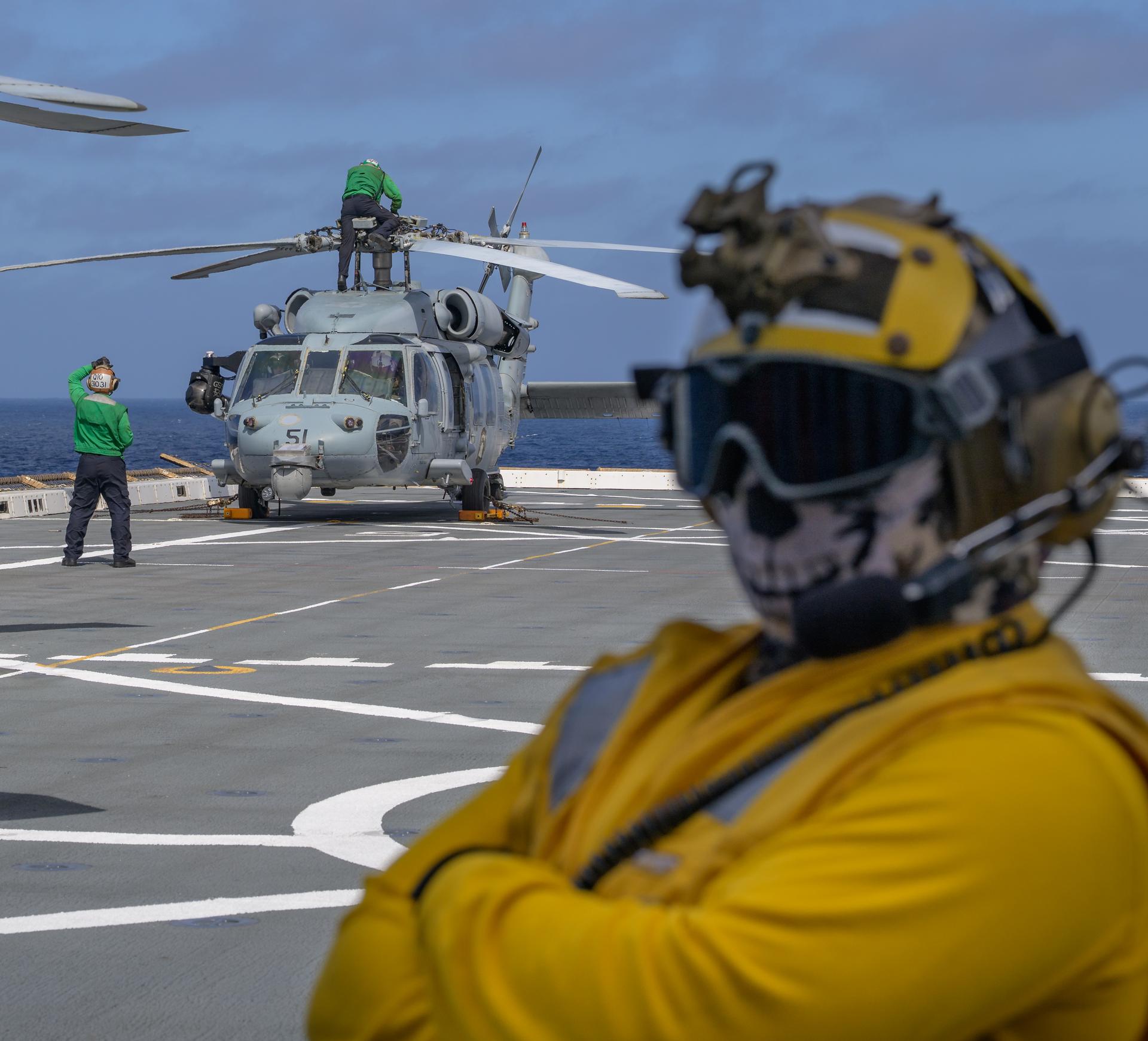 U.S. Navy MH-60 Seahawks from Helicopter Sea Combat Squadron (HSC) 23 are seen on the flight deck of USS John P. Murtha as they prepare to takeoff to conduct air operations training as NASA, U.S. Navy, and U.S. Air Force teams prepare for the the return of the Artemis II crewmembers to Earth, Tuesday, April 7, 2026, in the Pacific Ocean off the coast of California. NASA’s Artemis II mission is taking NASA astronauts Reid Wiseman, commander; Victor Glover, pilot; Christina Koch, mission specialist; and CSA (Canadian Space Agency) astronaut Jeremy Hansen, mission specialist on a 10-day journey around the Moon and back aboard their Orion spacecraft. Wiseman, Glover, Koch, and Hansen are scheduled to splash down off the coast of San Diego at approximately 5:07 p.m. PDT (8:07 p.m. EDT) on Friday, April 10.  Photo Credit: (NASA/Bill Ingalls)
