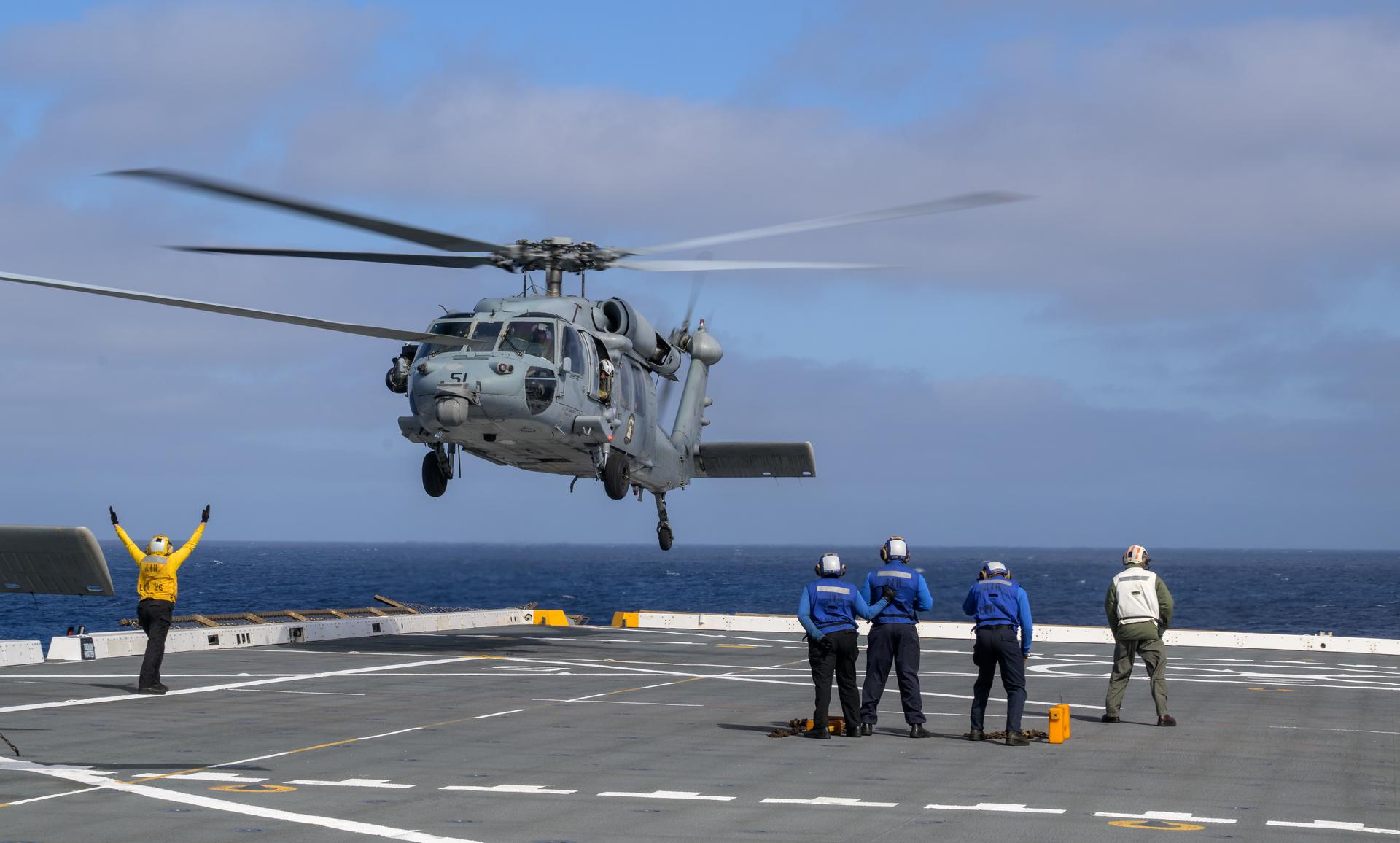 U.S. Navy MH-60 Seahawks from Helicopter Sea Combat Squadron (HSC) 23 are seen on the flight deck of USS John P. Murtha as they prepare to takeoff to conduct air operations training as NASA, U.S. Navy, and U.S. Air Force teams prepare for the the return of the Artemis II crewmembers to Earth, Tuesday, April 7, 2026, in the Pacific Ocean off the coast of California. NASA’s Artemis II mission is taking NASA astronauts Reid Wiseman, commander; Victor Glover, pilot; Christina Koch, mission specialist; and CSA (Canadian Space Agency) astronaut Jeremy Hansen, mission specialist on a 10-day journey around the Moon and back aboard their Orion spacecraft. Wiseman, Glover, Koch, and Hansen are scheduled to splash down off the coast of San Diego at approximately 5:07 p.m. PDT (8:07 p.m. EDT) on Friday, April 10.  Photo Credit: (NASA/Bill Ingalls)