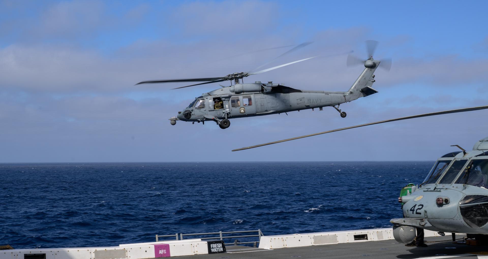 U.S. Navy MH-60 Seahawks from Helicopter Sea Combat Squadron (HSC) 23 depart USS John P. Murtha as they conduct air operations training as NASA, U.S. Navy, and U.S. Air Force teams prepare for the the return of the Artemis II crewmembers to Earth, Tuesday, April 7, 2026, in the Pacific Ocean off the coast of California. NASA’s Artemis II mission is taking NASA astronauts Reid Wiseman, commander; Victor Glover, pilot; Christina Koch, mission specialist; and CSA (Canadian Space Agency) astronaut Jeremy Hansen, mission specialist on a 10-day journey around the Moon and back aboard their Orion spacecraft. Wiseman, Glover, Koch, and Hansen are scheduled to splash down off the coast of San Diego at approximately 5:07 p.m. PDT (8:07 p.m. EDT) on Friday, April 10.  Photo Credit: (NASA/Bill Ingalls)