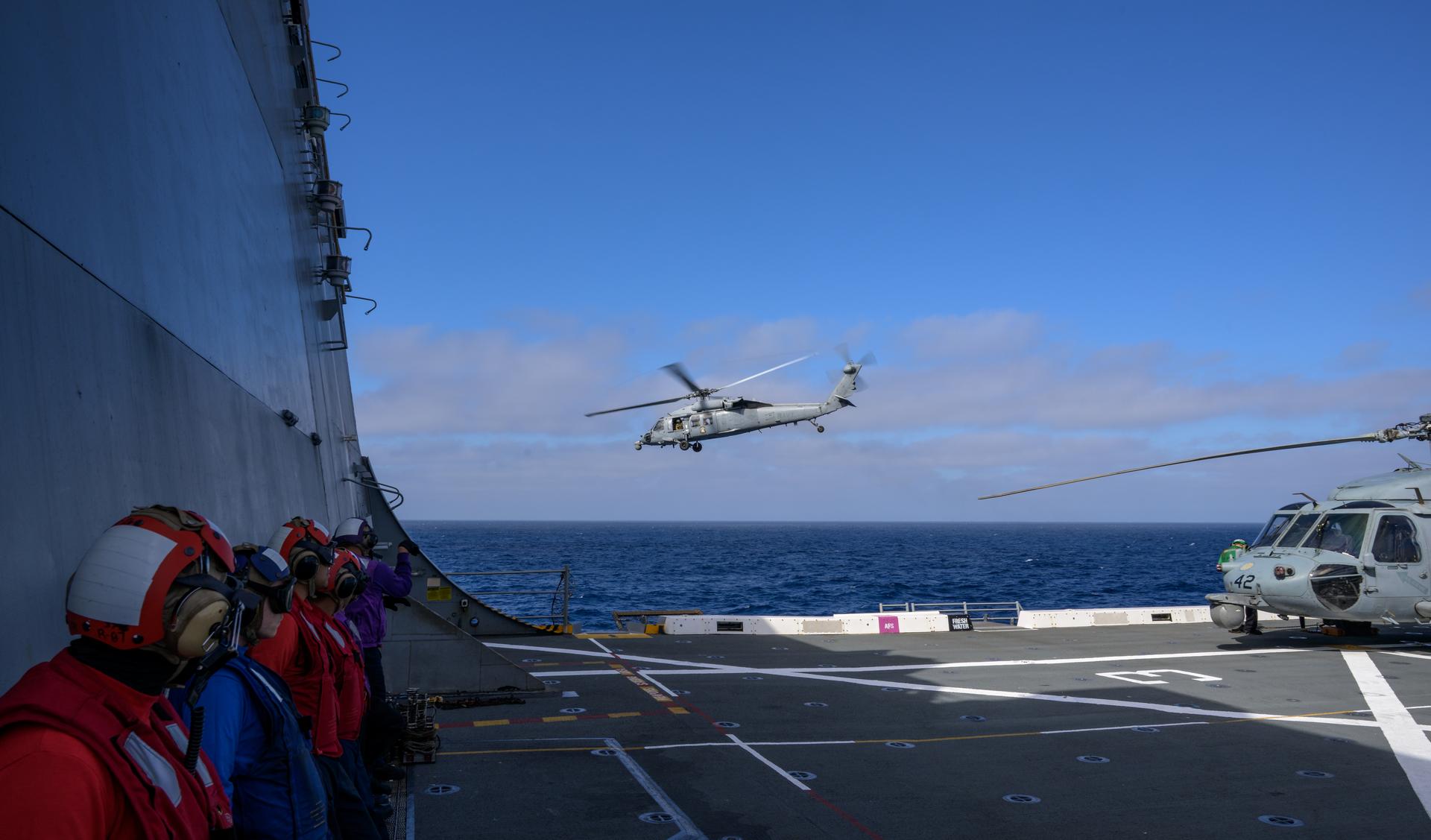 U.S. Navy MH-60 Seahawks from Helicopter Sea Combat Squadron (HSC) 23 depart USS John P. Murtha as they conduct air operations training as NASA, U.S. Navy, and U.S. Air Force teams prepare for the the return of the Artemis II crewmembers to Earth, Tuesday, April 7, 2026, in the Pacific Ocean off the coast of California. NASA’s Artemis II mission is taking NASA astronauts Reid Wiseman, commander; Victor Glover, pilot; Christina Koch, mission specialist; and CSA (Canadian Space Agency) astronaut Jeremy Hansen, mission specialist on a 10-day journey around the Moon and back aboard their Orion spacecraft. Wiseman, Glover, Koch, and Hansen are scheduled to splash down off the coast of San Diego at approximately 5:07 p.m. PDT (8:07 p.m. EDT) on Friday, April 10.  Photo Credit: (NASA/Bill Ingalls)