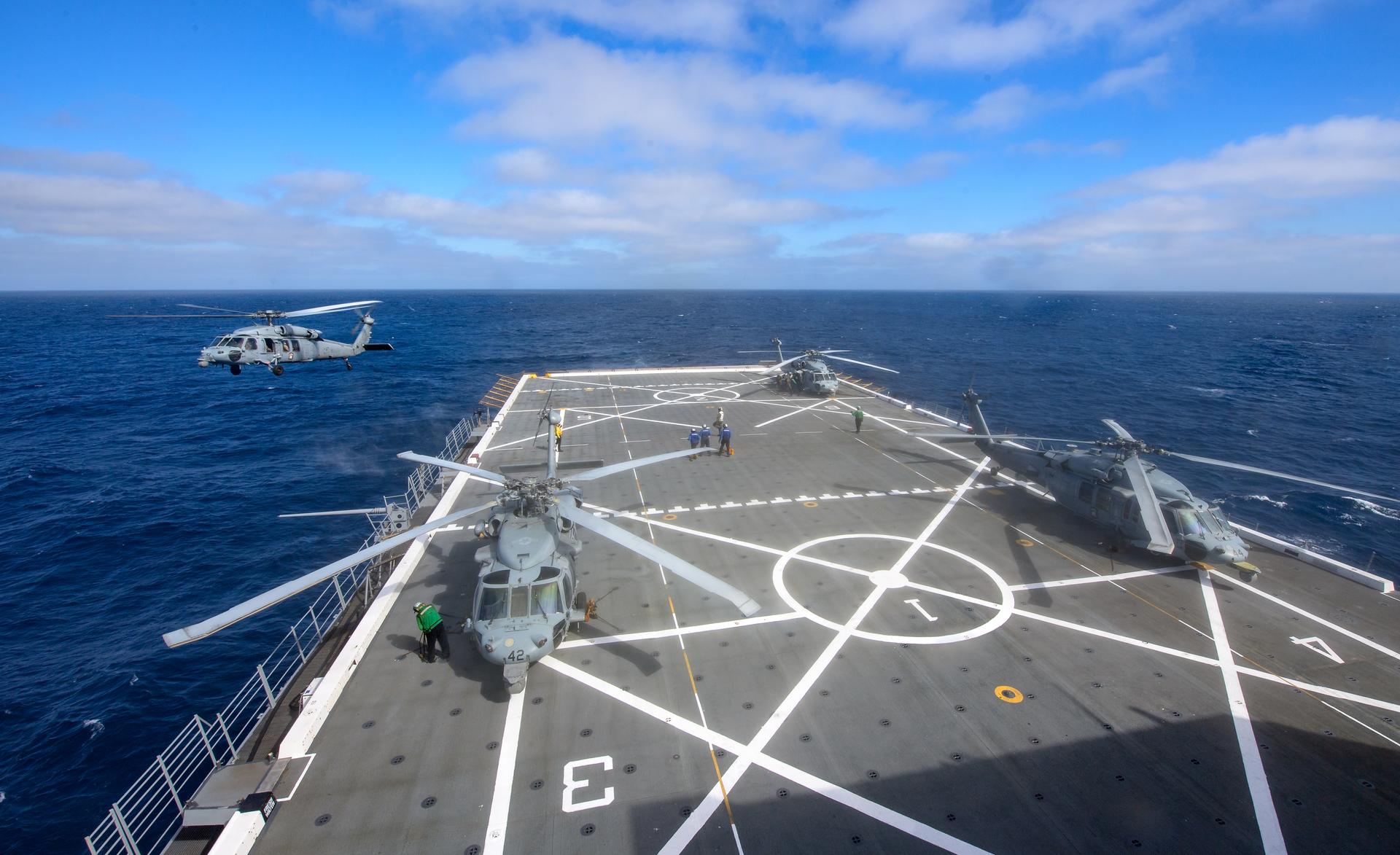 U.S. Navy MH-60 Seahawks from Helicopter Sea Combat Squadron (HSC) 23 on USS John P. Murtha prepare to conduct air operations training as NASA, U.S. Navy, and U.S. Air Force teams prepare for the the return of the Artemis II crewmembers to Earth, Tuesday, April 7, 2026, in the Pacific Ocean off the cost of California. NASA’s Artemis II mission is taking NASA astronauts Reid Wiseman, commander; Victor Glover, pilot; Christina Koch, mission specialist; and CSA (Canadian Space Agency) astronaut Jeremy Hansen, mission specialist on a 10-day journey around the Moon and back aboard their Orion spacecraft.Wiseman, Glover, Koch, and Hansen are scheduled to splash down off the coast of San Diego at approximately 5:07 p.m. PDT (8:07 p.m. EDT) on Friday, April 10.  Photo Credit: (NASA/Bill Ingalls)