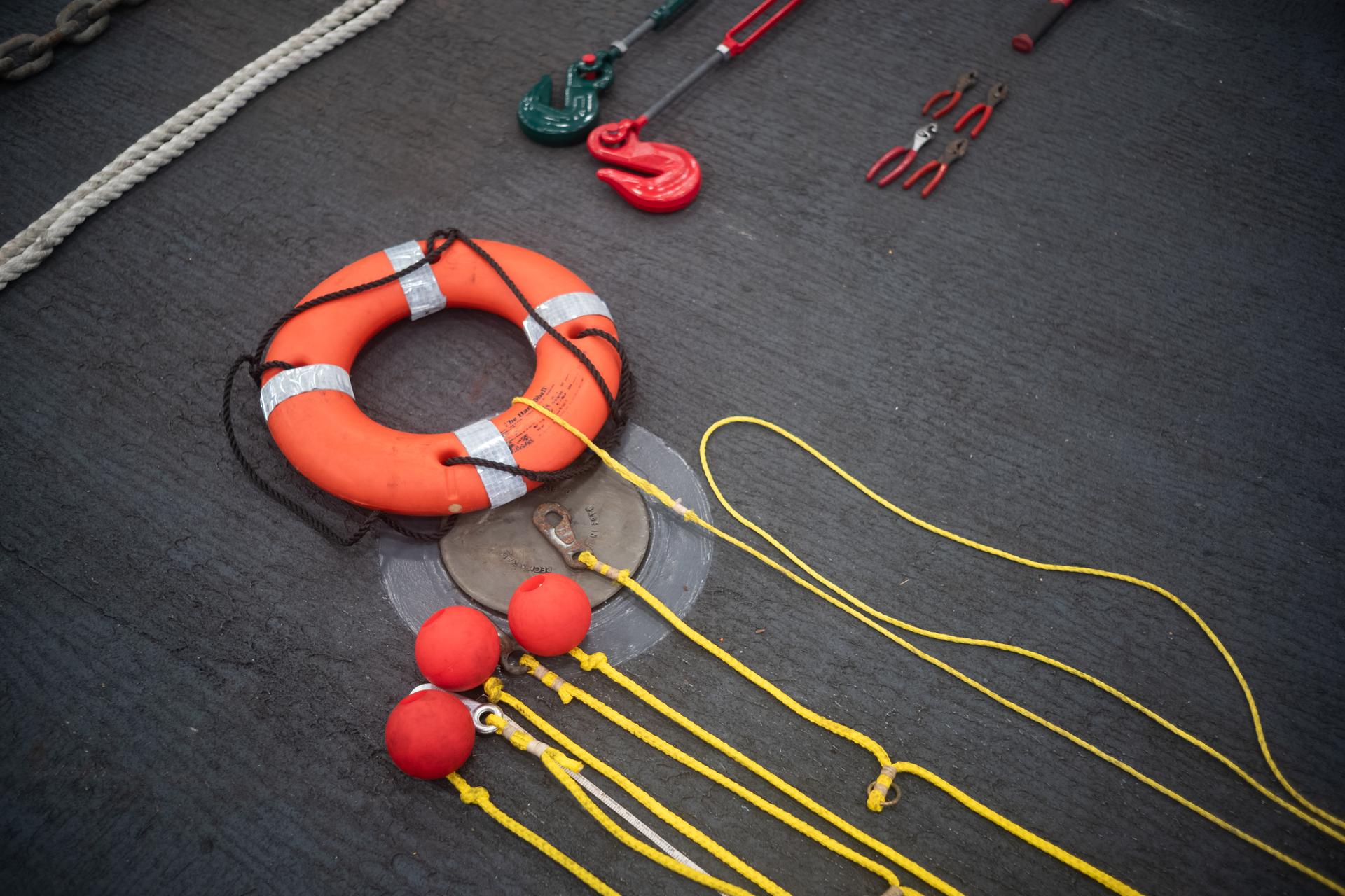 A life ring, throw ropes, and other equipment is seen laid out onboard USS John P. Murtha as NASA, U.S. Navy., and U.S. Air Force teams prepare for the the return of the Artemis II crewmembers to Earth, Wednesday, April 8, 2026, in the Pacific Ocean off the coast of California. NASA’s Artemis II mission is taking NASA astronauts Reid Wiseman, commander; Victor Glover, pilot; Christina Koch, mission specialist; and CSA (Canadian Space Agency) astronaut Jeremy Hansen, mission specialist on a 10-day journey around the Moon and back aboard their Orion spacecraft. Wiseman, Glover, Koch, and Hansen are scheduled to splash down off the coast of San Diego at approximately 5:07 p.m. PDT (8:07 p.m. EDT) on Friday, April 10.  Photo Credit: (NASA/Joel Kowsky)