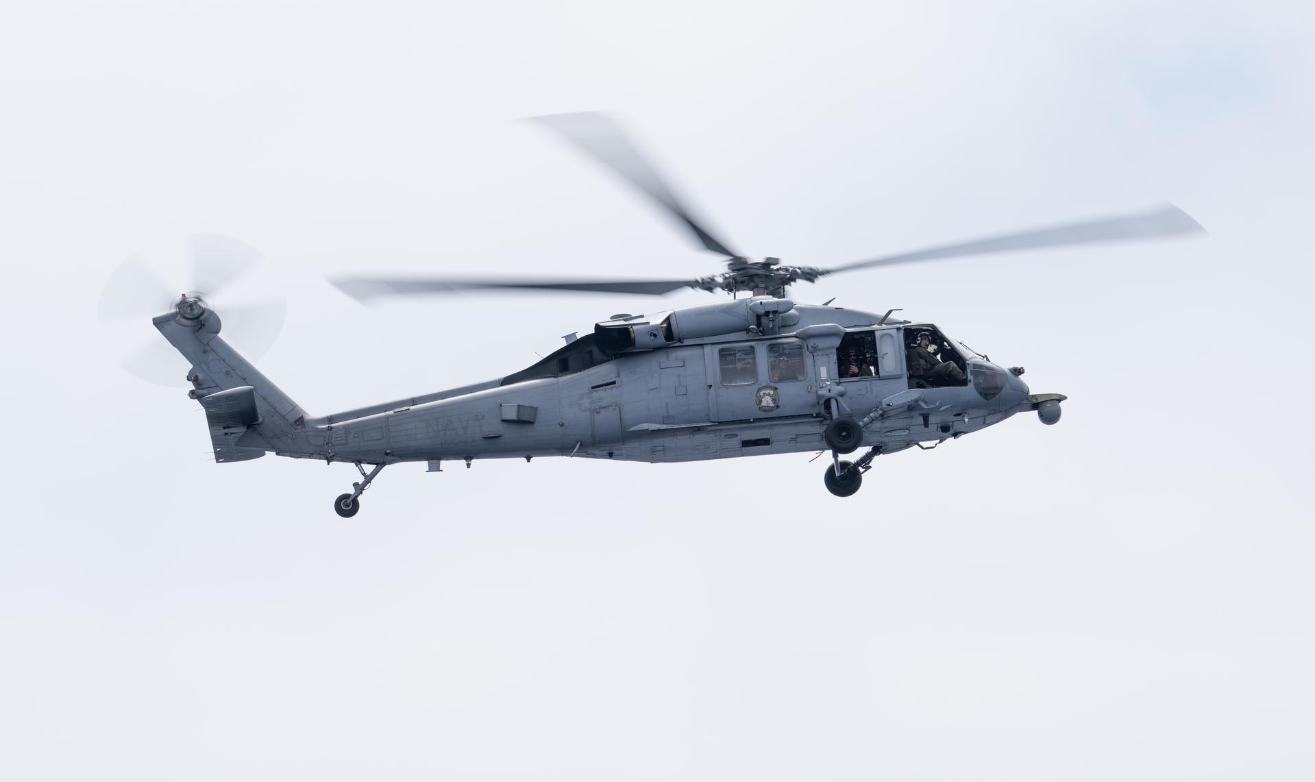 A U.S. Navy MH-60 Seahawk from Helicopter Sea Combat Squadron (HSC) 23 is seen as NASA, U.S. Navy, and U.S. Air Force teams onboard USS John P. Murtha prepare for the the return of the Artemis II crewmembers to Earth, Wednesday, April 8, 2026, in the Pacific Ocean off the coast of California. NASA’s Artemis II mission is taking NASA astronauts Reid Wiseman, commander; Victor Glover, pilot; Christina Koch, mission specialist; and CSA (Canadian Space Agency) astronaut Jeremy Hansen, mission specialist on a 10-day journey around the Moon and back aboard their Orion spacecraft. Wiseman, Glover, Koch, and Hansen are scheduled to splash down off the coast of San Diego at approximately 5:07 p.m. PDT (8:07 p.m. EDT) on Friday, April 10.  Photo Credit: (NASA/Joel Kowsky)