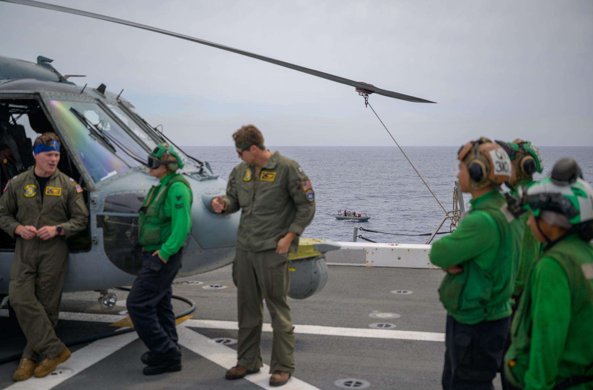 A support boat is seen along side USS John P. Murtha as teams prepare for the return of the Artemis II crewmembers to Earth, Thursday, April 9, 2026, in the Pacific Ocean off the coast of California. NASA’s Artemis II mission is taking NASA astronauts Reid Wiseman, commander; Victor Glover, pilot; Christina Koch, mission specialist; and CSA (Canadian Space Agency) astronaut Jeremy Hansen, mission specialist on a 10-day journey around the Moon and back aboard their Orion spacecraft. Wiseman, Glover, Koch, and Hansen are scheduled to splash down off the coast of San Diego at approximately 5:07 p.m. PDT (8:07 p.m. EDT) on Friday, April 10.  Photo Credit: (NASA/Bill Ingalls)