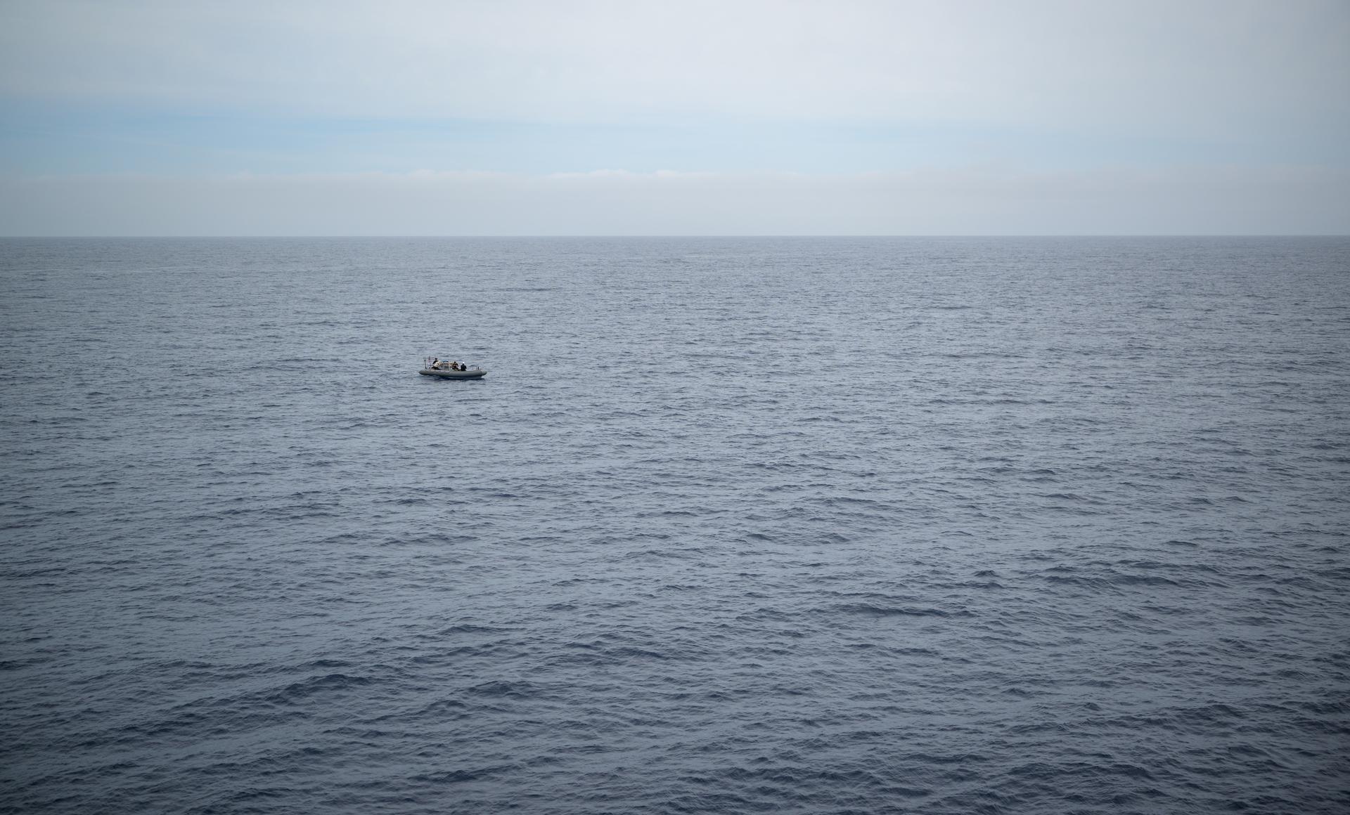 A support boat is seen along side USS John P. Murtha as teams prepare for the return of the Artemis II crewmembers to Earth, Thursday, April 9, 2026, in the Pacific Ocean off the coast of California. NASA’s Artemis II mission is taking NASA astronauts Reid Wiseman, commander; Victor Glover, pilot; Christina Koch, mission specialist; and CSA (Canadian Space Agency) astronaut Jeremy Hansen, mission specialist on a 10-day journey around the Moon and back aboard their Orion spacecraft. Wiseman, Glover, Koch, and Hansen are scheduled to splash down off the coast of San Diego at approximately 5:07 p.m. PDT (8:07 p.m. EDT) on Friday, April 10.  Photo Credit: (NASA/Bill Ingalls)