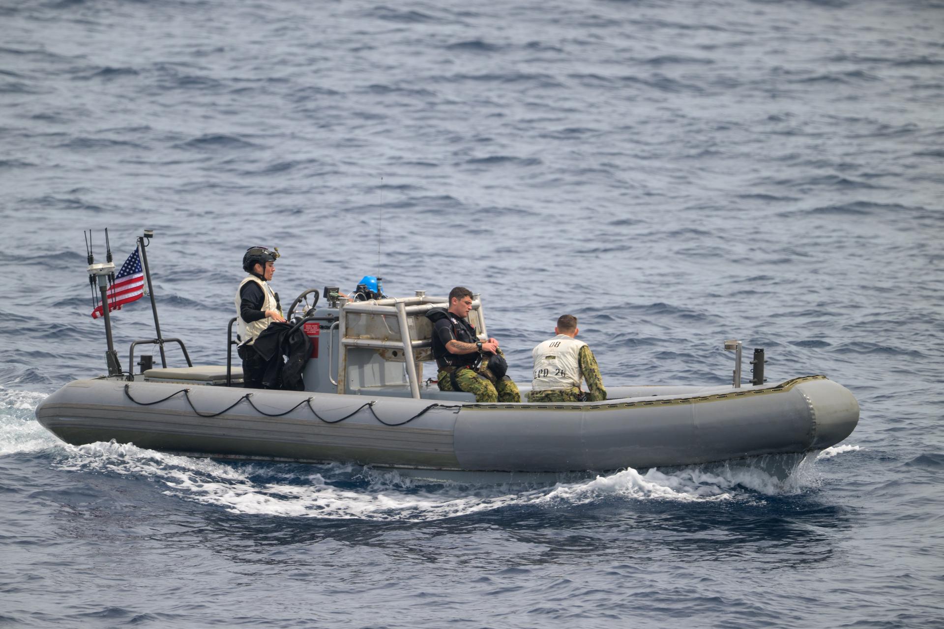 A support boat is seen along side USS John P. Murtha as teams prepare for the return of the Artemis II crewmembers to Earth, Thursday, April 9, 2026, in the Pacific Ocean off the coast of California. NASA’s Artemis II mission is taking NASA astronauts Reid Wiseman, commander; Victor Glover, pilot; Christina Koch, mission specialist; and CSA (Canadian Space Agency) astronaut Jeremy Hansen, mission specialist on a 10-day journey around the Moon and back aboard their Orion spacecraft. Wiseman, Glover, Koch, and Hansen are scheduled to splash down off the coast of San Diego at approximately 5:07 p.m. PDT (8:07 p.m. EDT) on Friday, April 10.  Photo Credit: (NASA/Bill Ingalls)