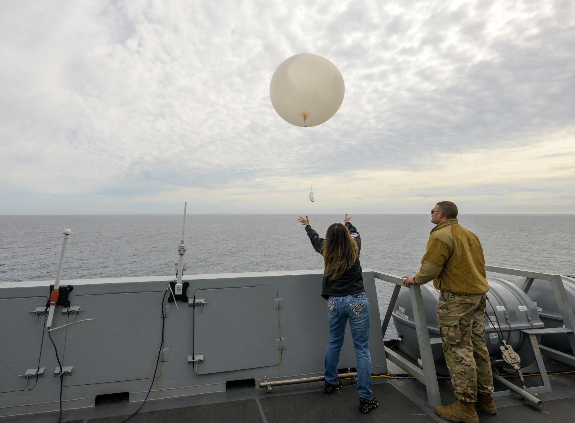 Lisa Seiler, Artemis Landing and Recovery Deputy Director,  and airmen of the 45th Weather Squadron release a weather balloon for launch as NASA, U.S. Navy, and U.S. Air Force teams continue to prepare for the the return of the Artemis II crewmembers to Earth, Thursday, April 9, 2026, onboard USS John P. Murtha in the Pacific Ocean off the coast of California. NASA’s Artemis II mission is taking NASA astronauts Reid Wiseman, commander; Victor Glover, pilot; Christina Koch, mission specialist; and CSA (Canadian Space Agency) astronaut Jeremy Hansen, mission specialist on a 10-day journey around the Moon and back aboard their Orion spacecraft. Wiseman, Glover, Koch, and Hansen are scheduled to splash down off the coast of San Diego at approximately 5:07 p.m. PDT (8:07 p.m. EDT) on Friday, April 10.  Photo Credit: (NASA/Bill Ingalls)