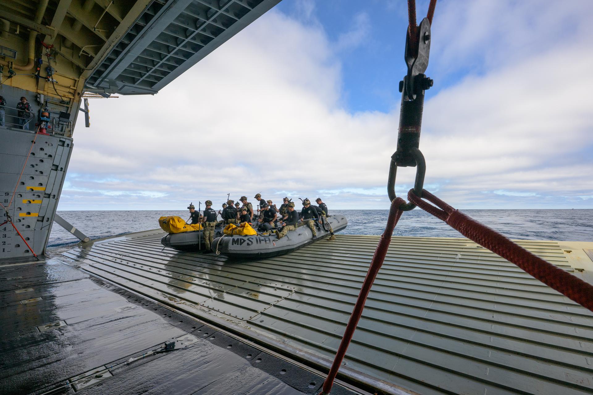 U.S. Navy divers prepare to deploy in small boats from the well deck of USS John P. Murtha to recover Artemis II crewmembers NASA astronauts Reid Wiseman, commander; Victor Glover, pilot; Christina Koch, mission specialist; and CSA (Canadian Space Agency) astronaut Jeremy Hansen, mission specialist and NASA’s Orion spacecraft in the Pacific Ocean off the coast of California, Friday, April 10, 2026. NASA’s Artemis II mission took Wiseman, Glover, Koch, and Hansen on a 10-day journey around the Moon and back to Earth. Following a splashdown at , NASA and U.S. military teams are working to bring the crewmembers and Orion spacecraft aboard USS John P. Murtha. Photo Credit: (NASA/Bill Ingalls)