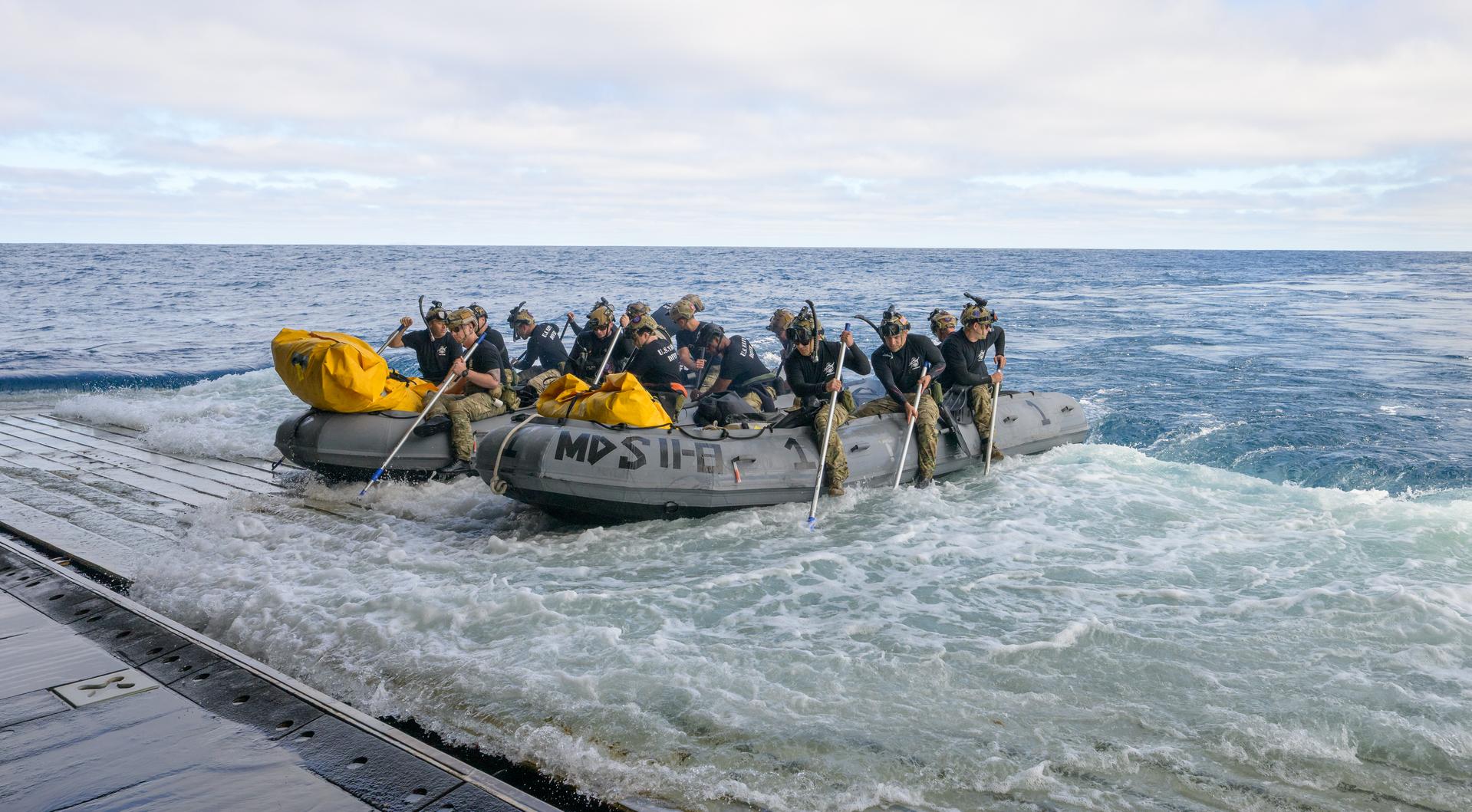 U.S. Navy divers prepare to deploy in small boats from the well deck of USS John P. Murtha to recover Artemis II crewmembers NASA astronauts Reid Wiseman, commander; Victor Glover, pilot; Christina Koch, mission specialist; and CSA (Canadian Space Agency) astronaut Jeremy Hansen, mission specialist and NASA’s Orion spacecraft in the Pacific Ocean off the coast of California, Friday, April 10, 2026. NASA’s Artemis II mission took Wiseman, Glover, Koch, and Hansen on a 10-day journey around the Moon and back to Earth. Following a splashdown at , NASA and U.S. military teams are working to bring the crewmembers and Orion spacecraft aboard USS John P. Murtha. Photo Credit: (NASA/Bill Ingalls)