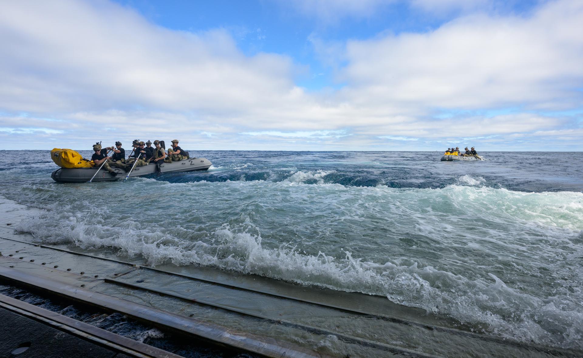 U.S. Navy divers deploy in small boats from the well deck of USS John P. Murtha to recover Artemis II crewmembers NASA astronauts Reid Wiseman, commander; Victor Glover, pilot; Christina Koch, mission specialist; and CSA (Canadian Space Agency) astronaut Jeremy Hansen, mission specialist and NASA’s Orion spacecraft in the Pacific Ocean off the coast of California, Friday, April 10, 2026. NASA’s Artemis II mission took Wiseman, Glover, Koch, and Hansen on a 10-day journey around the Moon and back to Earth. Following a splashdown at , NASA and U.S. military teams are working to bring the crewmembers and Orion spacecraft aboard USS John P. Murtha. Photo Credit: (NASA/Bill Ingalls)