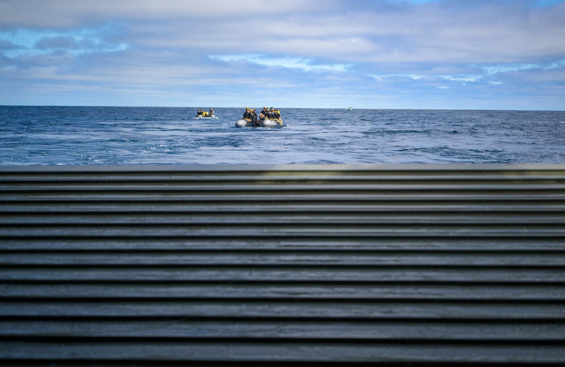 U.S. Navy divers deploy in small boats from the well deck of USS John P. Murtha to recover Artemis II crewmembers NASA astronauts Reid Wiseman, commander; Victor Glover, pilot; Christina Koch, mission specialist; and CSA (Canadian Space Agency) astronaut Jeremy Hansen, mission specialist and NASA’s Orion spacecraft in the Pacific Ocean off the coast of California, Friday, April 10, 2026. NASA’s Artemis II mission took Wiseman, Glover, Koch, and Hansen on a 10-day journey around the Moon and back to Earth. Following a splashdown at , NASA and U.S. military teams are working to bring the crewmembers and Orion spacecraft aboard USS John P. Murtha. Photo Credit: (NASA/Bill Ingalls)