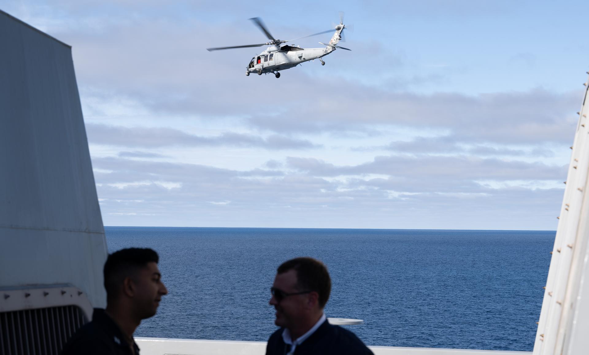 A U.S. Navy MH-60 Seahawk from Helicopter Sea Combat Squadron (HSC) 23 departs from the flight deck of USS John P. Murtha as NASA and U.S. military teams deploy in preparation for the the return of the Artemis II crewmembers to Earth, Friday, April 10, 2026, in the Pacific Ocean off the coast of California. NASA’s Artemis II mission is taking NASA astronauts Reid Wiseman, commander; Victor Glover, pilot; Christina Koch, mission specialist; and CSA (Canadian Space Agency) astronaut Jeremy Hansen, mission specialist on a 10-day journey around the Moon and back aboard their Orion spacecraft. Wiseman, Glover, Koch, and Hansen are scheduled to splash down off the coast of San Diego at approximately 5:07 p.m. PDT (8:07 p.m. EDT).  Photo Credit: (NASA/Joel Kowsky)