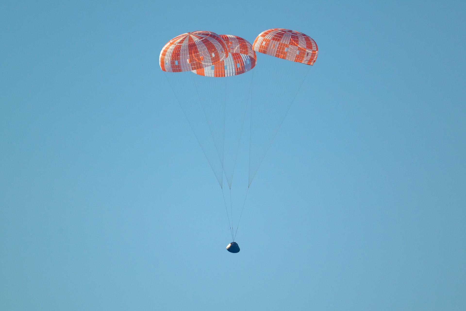 NASA’s Orion spacecraft with Artemis II crewmembers NASA astronauts Reid Wiseman, commander; Victor Glover, pilot; Christina Koch, mission specialist; and CSA (Canadian Space Agency) astronaut Jeremy Hansen, mission specialist aboard is seen under parachutes as it lands in the Pacific Ocean off the coast of California, Friday, April 10, 2026. NASA’s Artemis II mission took Wiseman, Glover, Koch, and Hansen on a nearly 10-day journey around the Moon and back to Earth. Following a splashdown at 8:07 p.m. EDT, NASA, U.S. Navy, and U.S. Air Force teams are working to bring the crewmembers and Orion spacecraft aboard USS John P. Murtha.  Photo Credit: (NASA/Bill Ingalls)