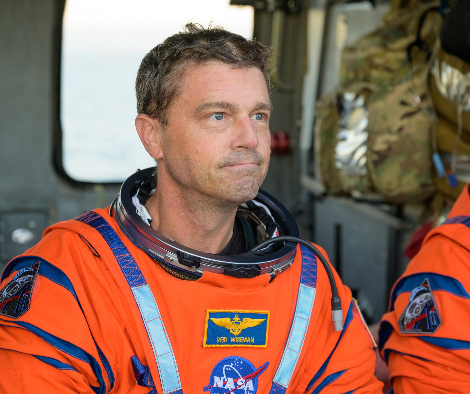 NASA astronaut Reid Wiseman, Artemis II commander is seen sitting in a Navy MH-60 Seahawk from Helicopter Sea Combat Squadron (HSC) 23 on the flight deck of USS John P. Murtha after he and fellow crewmates NASA Astronauts Victor Glover,  Christina Koch, and CSA (Canadian Space Agency) astronaut Jeremy Hansen, were extracted from their Orion spacecraft after splashdown, Friday, April 10, 2026, in the Pacific Ocean off the coast of California. NASA’s Artemis II mission took the quartet on a nearly 10-day journey around the Moon and back to Earth. Following a splashdown at 5:07 p.m. PDT (8:07 p.m. EDT), NASA, U.S. Navy, and U.S. Air Force teams are working to bring the Orion spacecraft aboard the recovery ship. Photo Credit: (NASA/Bill Ingalls)