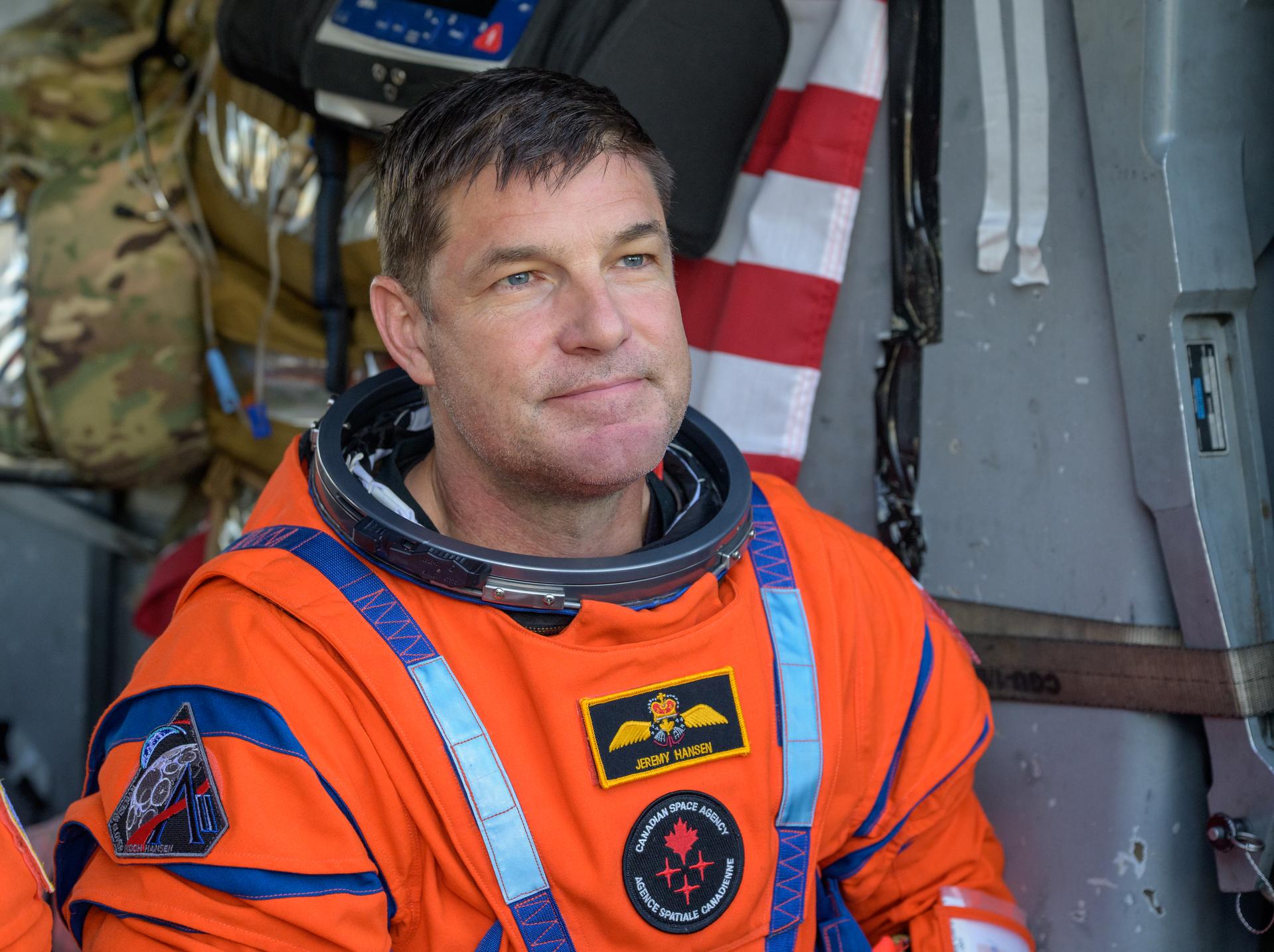 CSA (Canadian Space Agency) astronaut Jeremy Hansen, Artemis II mission specialist is seen sitting in a Navy MH-60 Seahawk from Helicopter Sea Combat Squadron (HSC) 23 on the flight deck of USS John P. Murtha after he and fellow crewmates NASA Astronauts Reid Wiseman, Victor Glover, and Christina Koch, were extracted from their Orion spacecraft after splashdown, Friday, April 10, 2026, in the Pacific Ocean off the coast of California. NASA’s Artemis II mission took the quartet on a nearly 10-day journey around the Moon and back to Earth. Following a splashdown at 5:07 p.m. PDT (8:07 p.m. EDT), NASA, U.S. Navy, and U.S. Air Force teams are working to bring the Orion spacecraft aboard the recovery ship. Photo Credit: (NASA/Bill Ingalls)