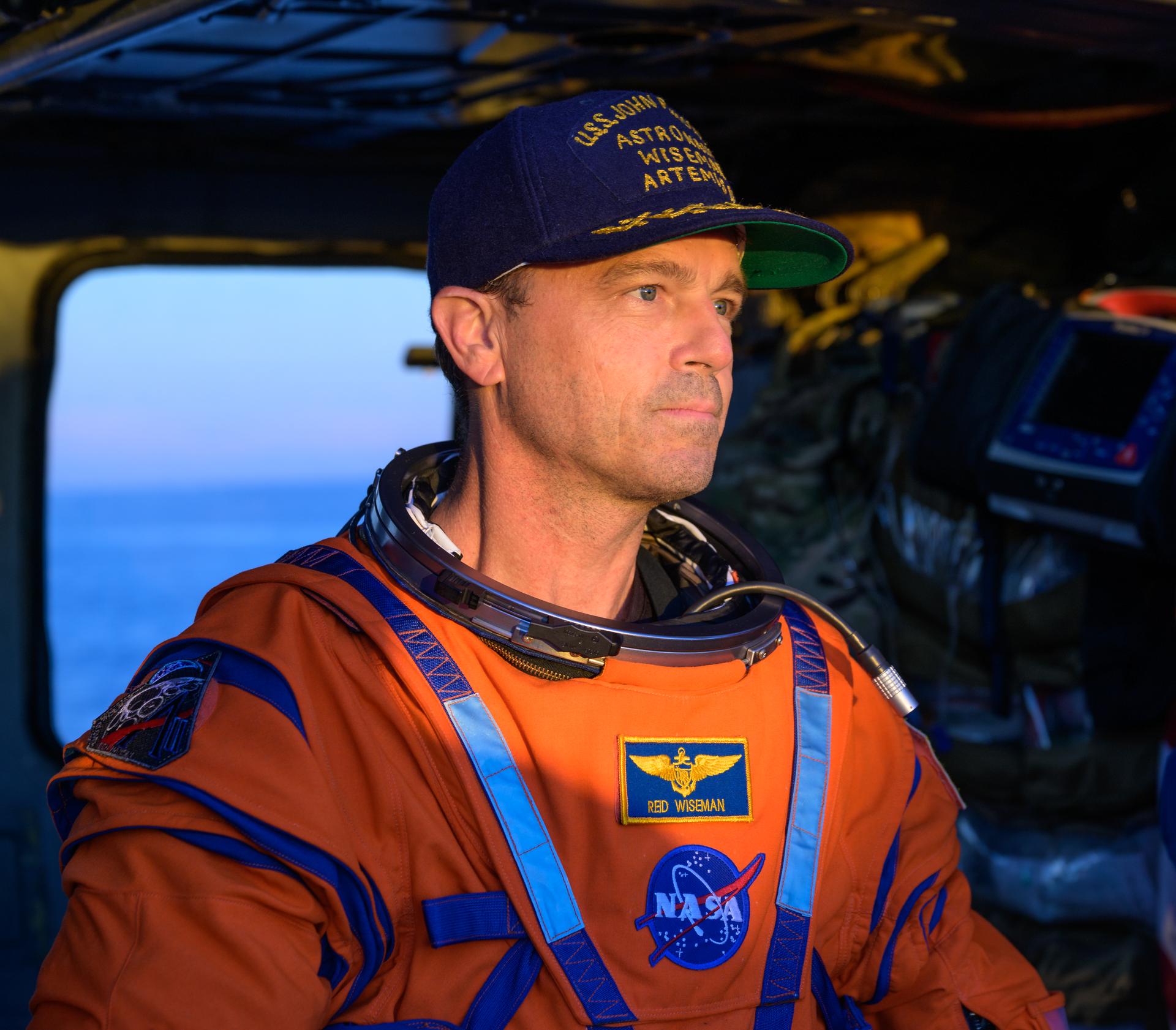 NASA astronaut Reid Wiseman, Artemis II commander is seen sitting in a Navy MH-60 Seahawk from Helicopter Sea Combat Squadron (HSC) 23 on the flight deck of USS John P. Murtha after he and fellow crewmates NASA Astronauts Victor Glover,  Christina Koch, and CSA (Canadian Space Agency) astronaut Jeremy Hansen, were extracted from their Orion spacecraft after splashdown, Friday, April 10, 2026, in the Pacific Ocean off the coast of California. NASA’s Artemis II mission took the quartet on a nearly 10-day journey around the Moon and back to Earth. Following a splashdown at 5:07 p.m. PDT (8:07 p.m. EDT), NASA, U.S. Navy, and U.S. Air Force teams are working to bring the Orion spacecraft aboard the recovery ship. Photo Credit: (NASA/Bill Ingalls)