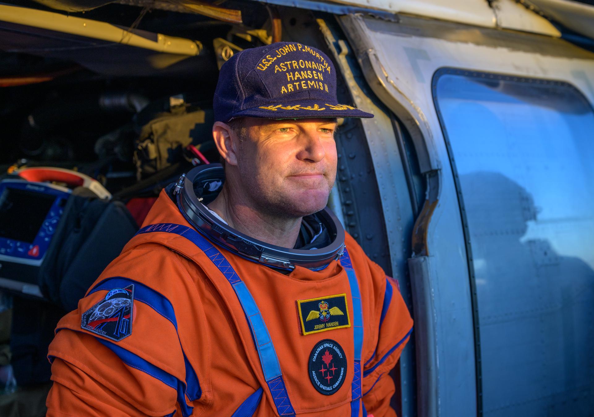 CSA (Canadian Space Agency) astronaut Jeremy Hansen, Artemis II mission specialist is seen sitting in a Navy MH-60 Seahawk from Helicopter Sea Combat Squadron (HSC) 23 on the flight deck of USS John P. Murtha after he and fellow crewmates NASA Astronauts Reid Wiseman, Victor Glover, and Christina Koch, were extracted from their Orion spacecraft after splashdown, Friday, April 10, 2026, in the Pacific Ocean off the coast of California. NASA’s Artemis II mission took the quartet on a nearly 10-day journey around the Moon and back to Earth. Following a splashdown at 5:07 p.m. PDT (8:07 p.m. EDT), NASA, U.S. Navy, and U.S. Air Force teams are working to bring the Orion spacecraft aboard the recovery ship. Photo Credit: (NASA/Bill Ingalls)