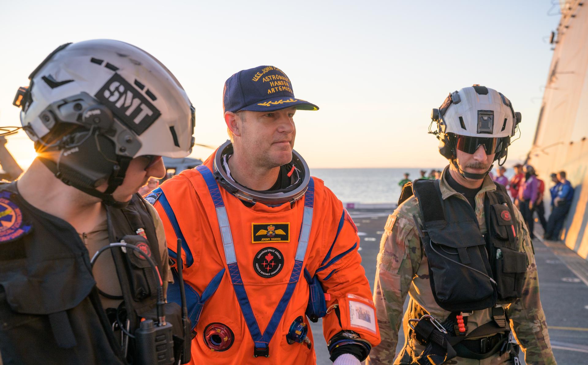 CSA (Canadian Space Agency) astronaut Jeremy Hansen, Artemis II mission specialist is assisted off the flight deck after arriving aboard USS John P. Murtha with fellow crewmates NASA astronauts Reid Wiseman, commander; Victor Glover, pilot; and Christina Koch, mission specialist were extracted from their Orion spacecraft after splashdown, Friday, April 10, 2026, in the Pacific Ocean off the coast of California. NASA’s Artemis II mission took the quartet on a nearly 10-day journey around the Moon and back to Earth. Following a splashdown at 5:07 p.m. PDT (8:07 p.m. EDT), NASA, U.S. Navy, and U.S. Air Force teams are working to bring the Orion spacecraft aboard the recovery ship. Photo Credit: (NASA/Bill Ingalls)