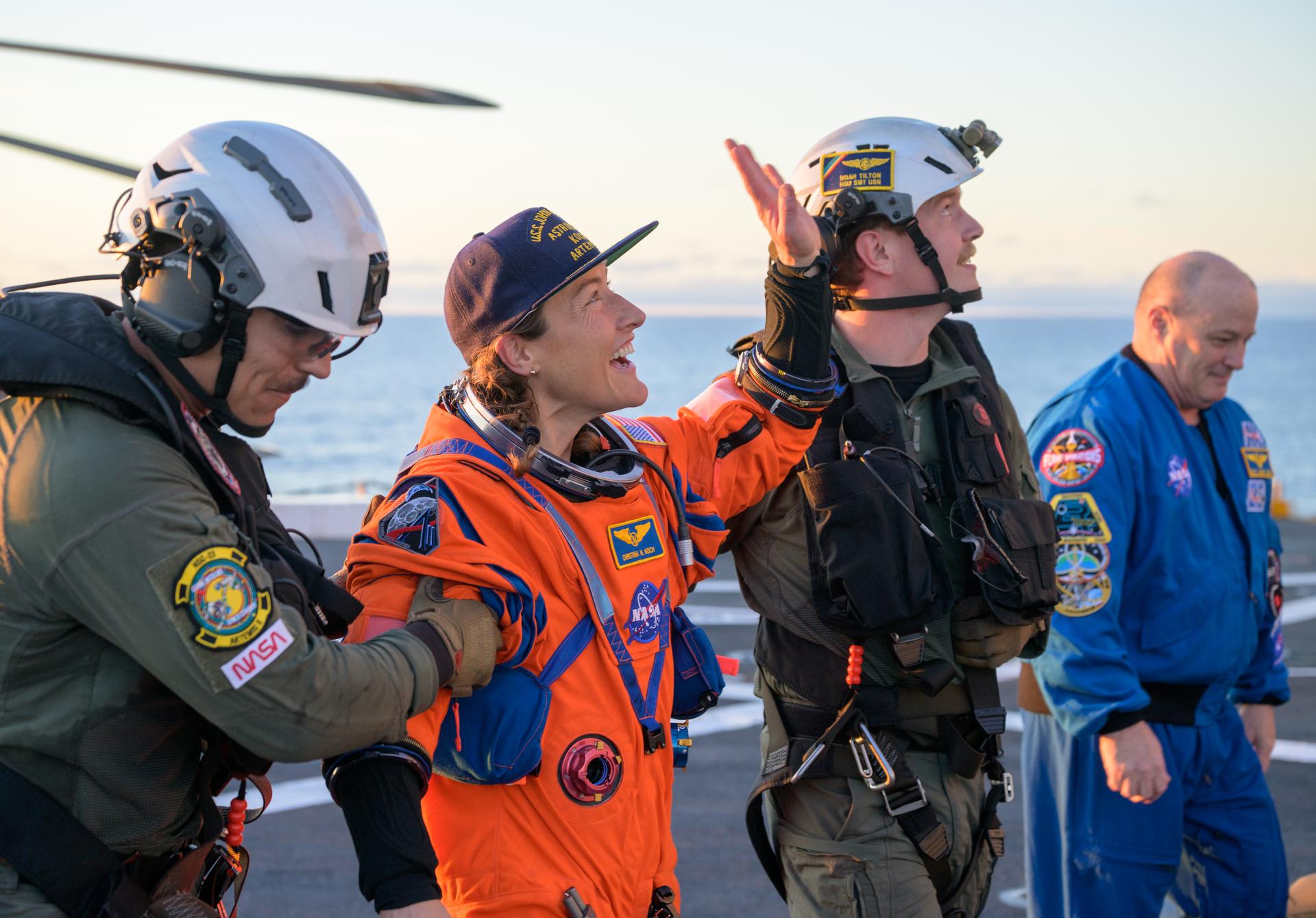 NASA astronaut Christina Koch, Artemis II mission specialist is assisted off the flight deck after arriving aboard USS John P. Murtha after she and fellow crewmates NASA astronauts Reid Wiseman, commander; Victor Glover, pilot; and CSA (Canadian Space Agency) astronaut Jeremy Hansen, mission specialist were extracted from their Orion spacecraft after splashdown, Friday, April 10, 2026, in the Pacific Ocean off the coast of California. NASA’s Artemis II mission took the quartet on a 10-day journey around the Moon and back to Earth. Following a splashdown at , NASA and U.S. military teams are working to bring the crewmembers and Orion spacecraft aboard the recovery ship. Photo Credit: (NASA/Bill Ingalls)