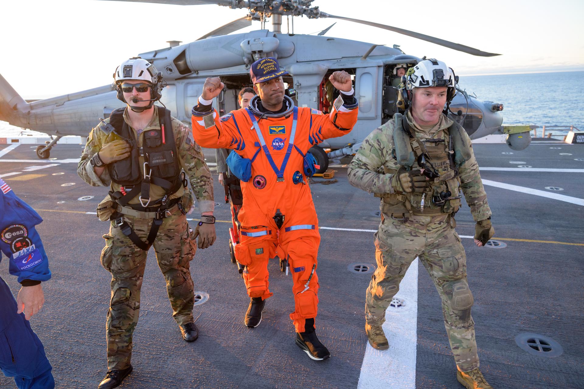 NASA astronaut Victor Glover, Artemis II pilot is assisted off the flight deck after arriving aboard USS John P. Murtha  after he and fellow crewmates NASA astronauts Reid Wiseman, commander; Christina Koch, mission specialist; and CSA (Canadian Space Agency) astronaut Jeremy Hansen, mission specialist were extracted from their Orion spacecraft after splashdown, Friday, April 10, 2026, in the Pacific Ocean off the coast of California. NASA’s Artemis II mission took the quartet on a 10-day journey around the Moon and back to Earth. Following a splashdown at , NASA and U.S. military teams are working to bring the crewmembers and Orion spacecraft aboard the recovery ship. Photo Credit: (NASA/Bill Ingalls)
