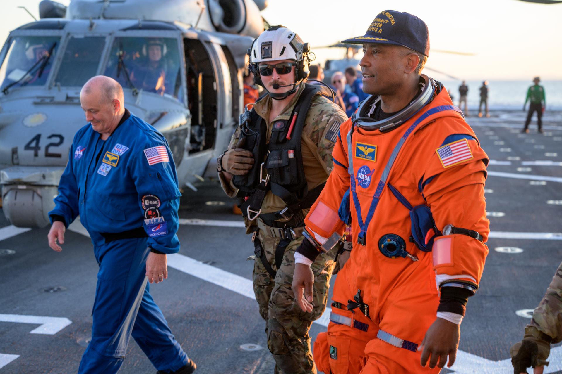 NASA astronaut Victor Glover, Artemis II pilot is assisted off the flight deck after arriving aboard USS John P. Murtha  after he and fellow crewmates NASA astronauts Reid Wiseman, commander; Christina Koch, mission specialist; and CSA (Canadian Space Agency) astronaut Jeremy Hansen, mission specialist were extracted from their Orion spacecraft after splashdown, Friday, April 10, 2026, in the Pacific Ocean off the coast of California. NASA’s Artemis II mission took the quartet on a 10-day journey around the Moon and back to Earth. Following a splashdown at , NASA and U.S. military teams are working to bring the crewmembers and Orion spacecraft aboard the recovery ship. Photo Credit: (NASA/Bill Ingalls)