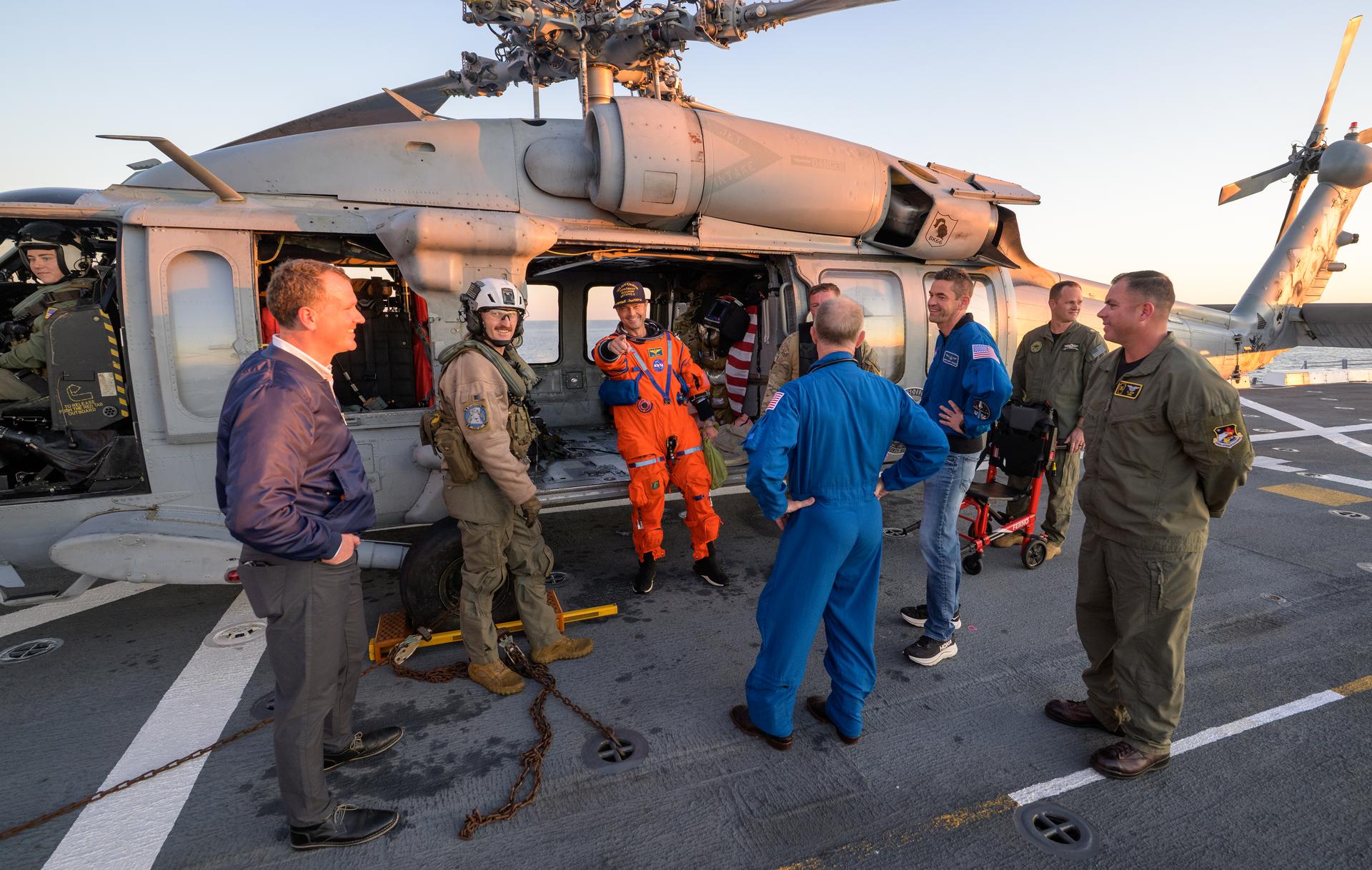 NASA astronaut Reid Wiseman, Artemis II commander is seen sitting in a Navy MH-60 Seahawk from Helicopter Sea Combat Squadron (HSC) 23 on the flight deck of USS John P. Murtha after he and fellow crewmates NASA Astronauts Victor Glover,  Christina Koch, and CSA (Canadian Space Agency) astronaut Jeremy Hansen, were extracted from their Orion spacecraft after splashdown, Friday, April 10, 2026, in the Pacific Ocean off the coast of California. NASA’s Artemis II mission took the quartet on a nearly 10-day journey around the Moon and back to Earth. Following a splashdown at 5:07 p.m. PDT (8:07 p.m. EDT), NASA, U.S. Navy, and U.S. Air Force teams are working to bring the Orion spacecraft aboard the recovery ship. Photo Credit: (NASA/Bill Ingalls)