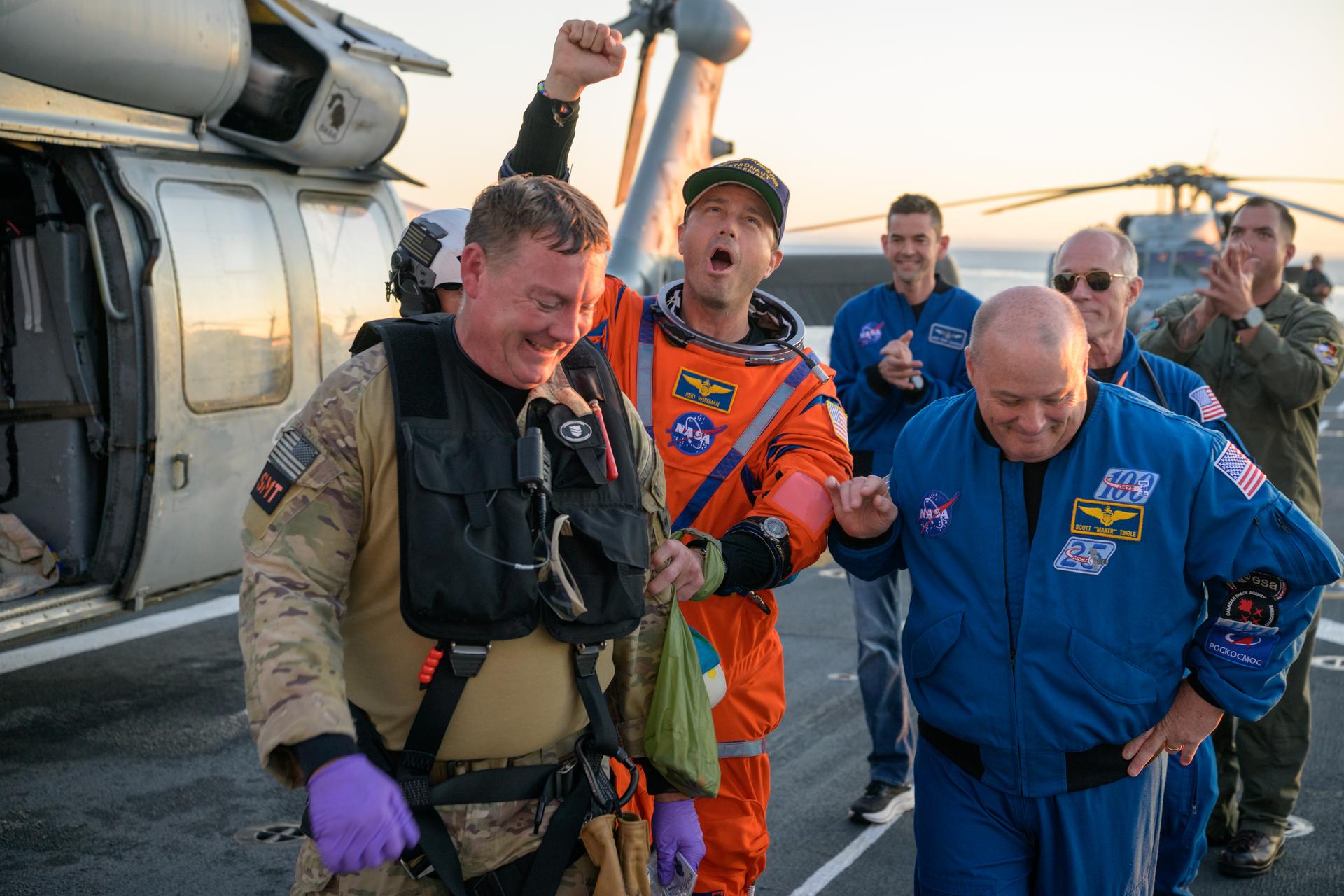 NASA astronaut Reid Wiseman, Artemis II commander is assisted off the flight deck after arriving aboard USS John P. Murtha after he and fellow crewmates NASA Astronauts Victor Glover, Christina Koch, and CSA (Canadian Space Agency) astronaut Jeremy Hansen, were extracted from their Orion spacecraft after splashdown, Friday, April 10, 2026, in the Pacific Ocean off the coast of California. NASA’s Artemis II mission took the quartet on a 10-day journey around the Moon and back to Earth. Following a splashdown at , NASA and U.S. military teams are working to bring the crewmembers and Orion spacecraft aboard the recovery ship. Photo Credit: (NASA/Bill Ingalls)