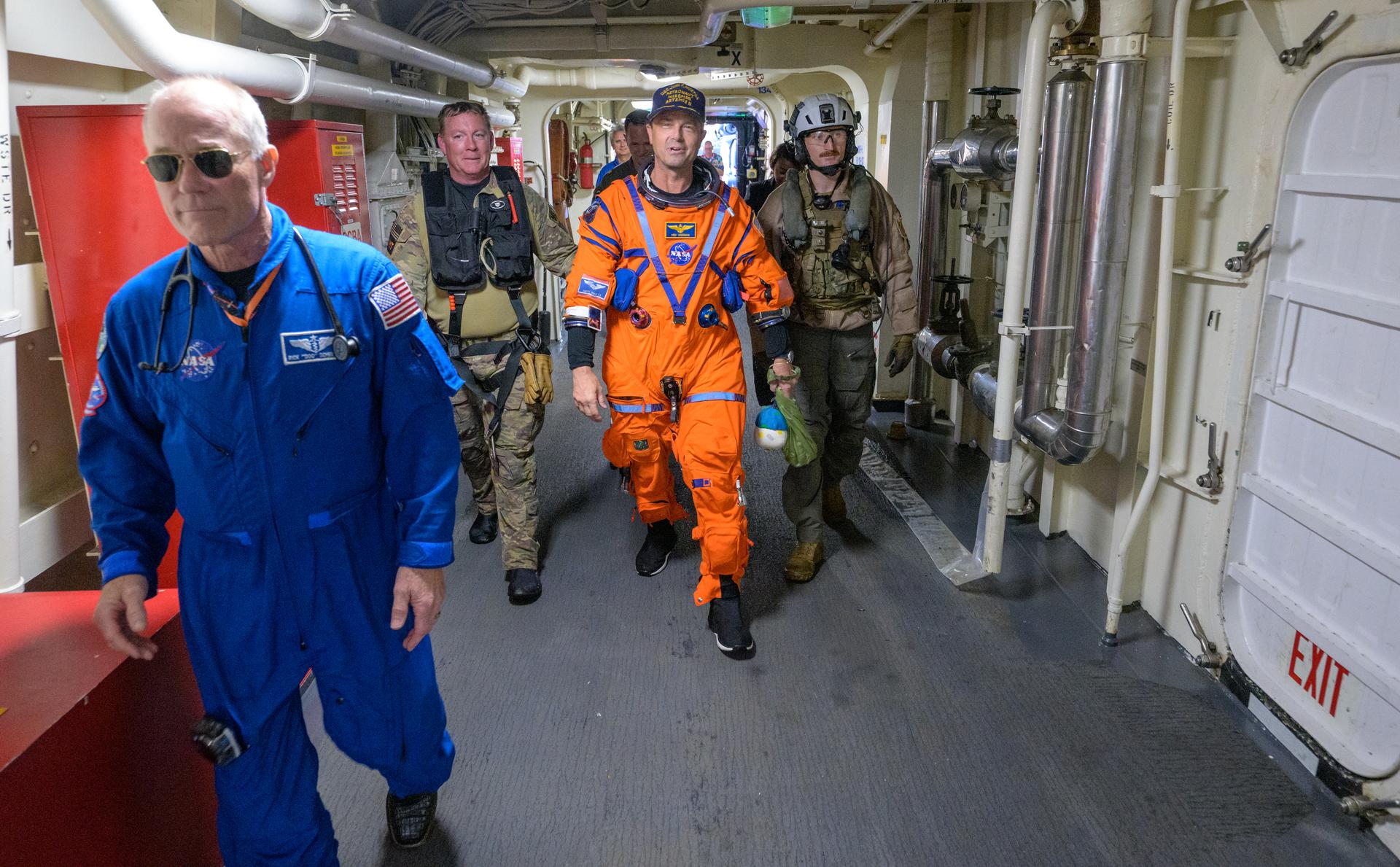 NASA astronaut Reid Wiseman, Artemis II commander is assisted off the flight deck after arriving aboard USS John P. Murtha after he and fellow crewmates NASA Astronauts Victor Glover, Christina Koch, and CSA (Canadian Space Agency) astronaut Jeremy Hansen, were extracted from their Orion spacecraft after splashdown, Friday, April 10, 2026, in the Pacific Ocean off the coast of California. NASA’s Artemis II mission took the quartet on a 10-day journey around the Moon and back to Earth. Following a splashdown at , NASA and U.S. military teams are working to bring the crewmembers and Orion spacecraft aboard the recovery ship. Photo Credit: (NASA/Bill Ingalls)