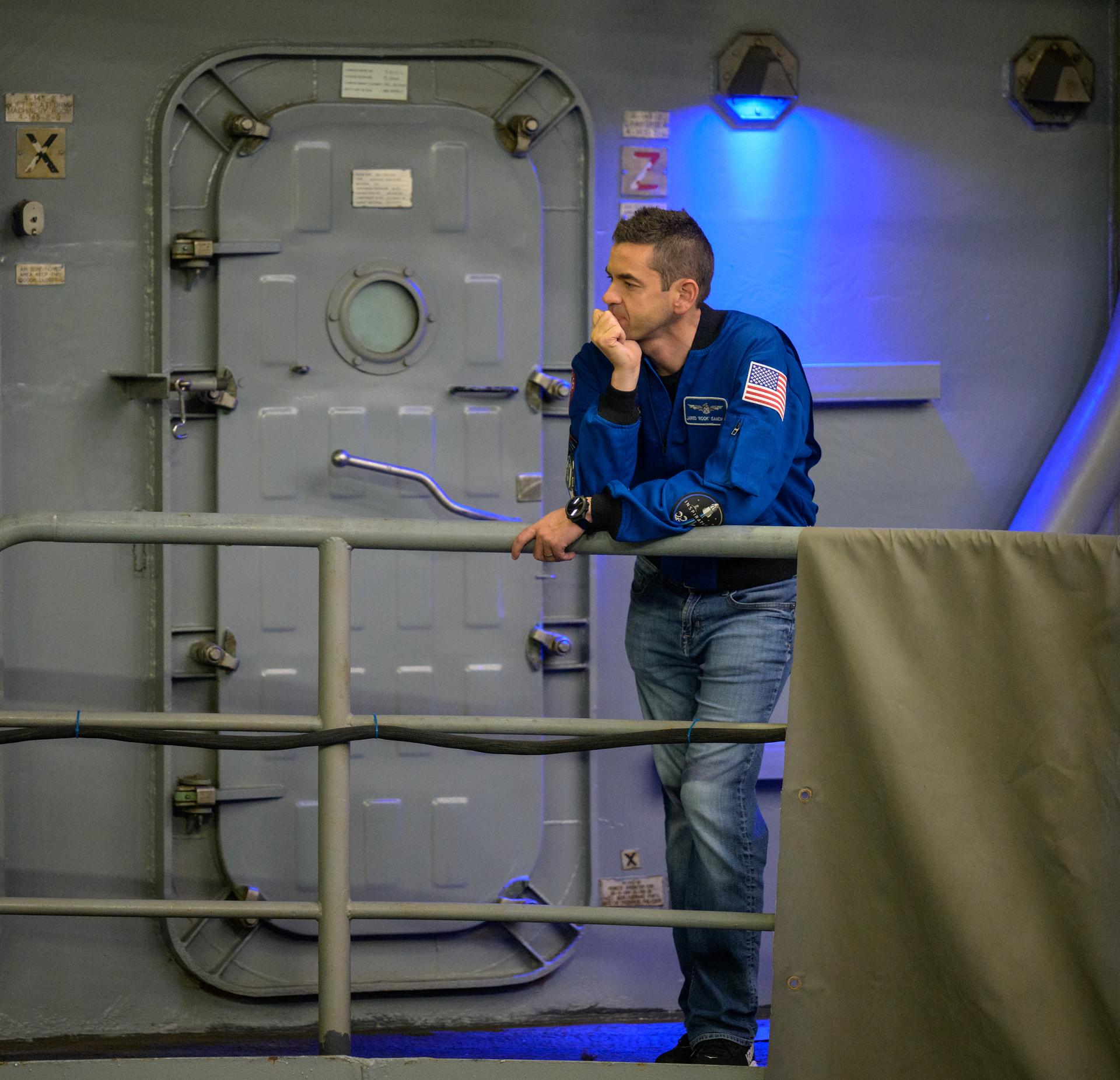 NASA Administrator Jared Isaacman monitors operations as teams prepare to recover NASA’s Orion spacecraft into the well deck of USS John P. Murtha in the Pacific Ocean off the coast of California, Friday, April 10, 2026. NASA’s Artemis II mission, which took NASA astronauts Reid Wiseman, commander; Victor Glover, pilot; Christina Koch, mission specialist; and CSA (Canadian Space Agency) astronaut Jeremy Hansen, mission specialist on a nearly 10-day journey around the Moon and back to Earth, splashed down at 5:07 p.m. PDT (8:07 p.m. EDT).  Photo Credit: (NASA/Bill Ingalls)