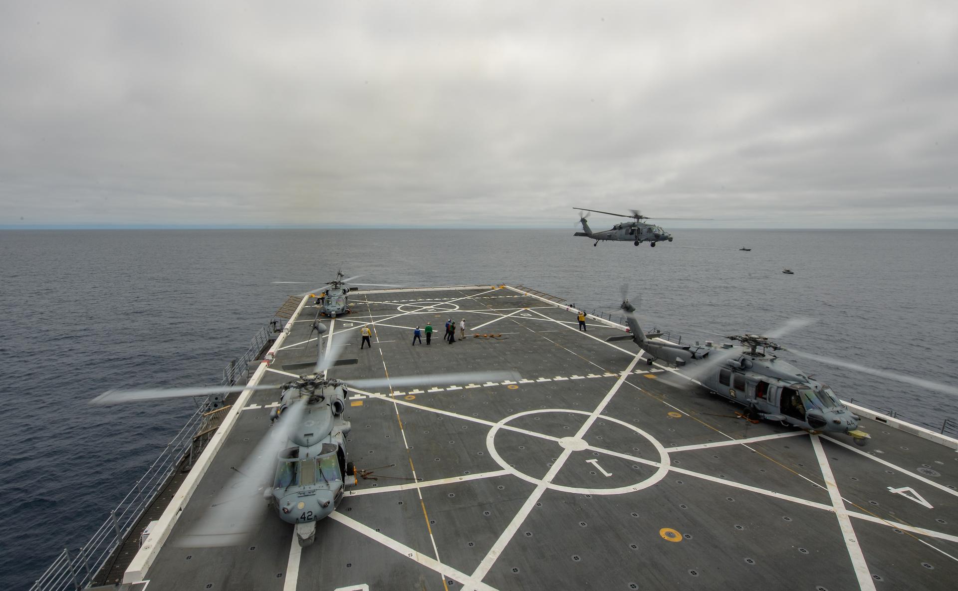 U.S. Navy MH-60 Seahawks from Helicopter Sea Combat Squadron (HSC) 23 are seen on the flight deck of USS John P. Murtha as NASA, U.S. Navy, and U.S. Air Force teams prepare for the the return of the Artemis II crewmembers to Earth, Friday, April 10, 2026, in the Pacific Ocean off the coast of California. NASA’s Artemis II mission is taking NASA astronauts Reid Wiseman, commander; Victor Glover, pilot; Christina Koch, mission specialist; and CSA (Canadian Space Agency) astronaut Jeremy Hansen, mission specialist on a nearly 10-day journey around the Moon and back aboard their Orion spacecraft. Wiseman, Glover, Koch, and Hansen are scheduled to splash down off the coast of San Diego at approximately 5:07 p.m. PDT (8:07 p.m. EDT) on Friday, April 10.  Photo Credit: (NASA/Bill Ingalls/Joel Kowsky)