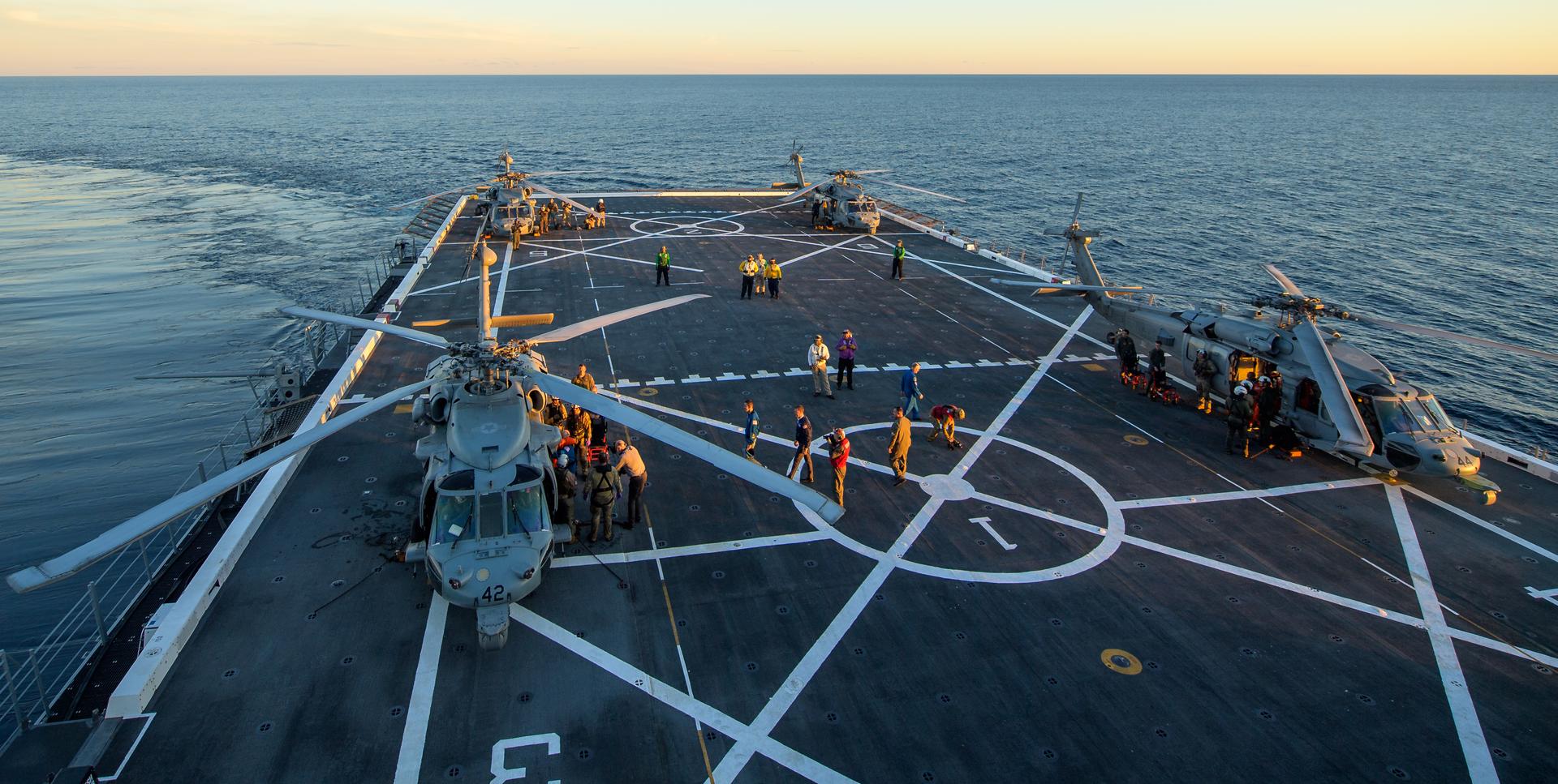 U.S. Navy MH-60 Seahawks from Helicopter Sea Combat Squadron (HSC) 23 are seen on the flight deck of USS John P. Murtha as NASA, U.S. Navy, and U.S. Air Force teams return with the Artemis II crewmembers, Friday, April 10, 2026, in the Pacific Ocean off the coast of California. NASA’s Artemis II mission is taking NASA astronauts Reid Wiseman, commander; Victor Glover, pilot; Christina Koch, mission specialist; and CSA (Canadian Space Agency) astronaut Jeremy Hansen, mission specialist on a nearly 10-day journey around the Moon and back aboard their Orion spacecraft. Wiseman, Glover, Koch, and Hansen are scheduled to splash down off the coast of San Diego at approximately 5:07 p.m. PDT (8:07 p.m. EDT) on Friday, April 10.  Photo Credit: (NASA/Bill Ingalls/Joel Kowsky)
