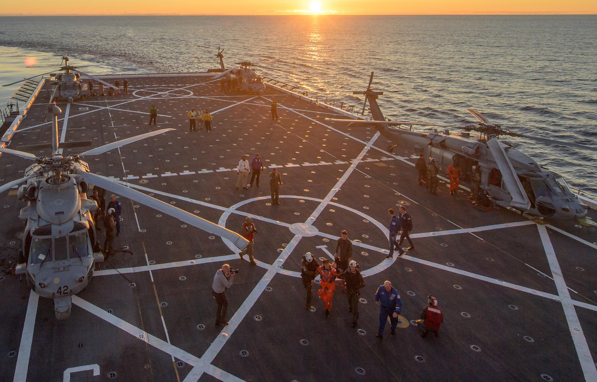 U.S. Navy MH-60 Seahawks from Helicopter Sea Combat Squadron (HSC) 23 are seen on the flight deck of USS John P. Murtha as NASA, U.S. Navy, and U.S. Air Force teams return with the Artemis II crewmembers, Friday, April 10, 2026, in the Pacific Ocean off the coast of California. NASA’s Artemis II mission is taking NASA astronauts Reid Wiseman, commander; Victor Glover, pilot; Christina Koch, mission specialist; and CSA (Canadian Space Agency) astronaut Jeremy Hansen, mission specialist on a nearly 10-day journey around the Moon and back aboard their Orion spacecraft. Wiseman, Glover, Koch, and Hansen are scheduled to splash down off the coast of San Diego at approximately 5:07 p.m. PDT (8:07 p.m. EDT) on Friday, April 10.  Photo Credit: (NASA/Bill Ingalls/Joel Kowsky)