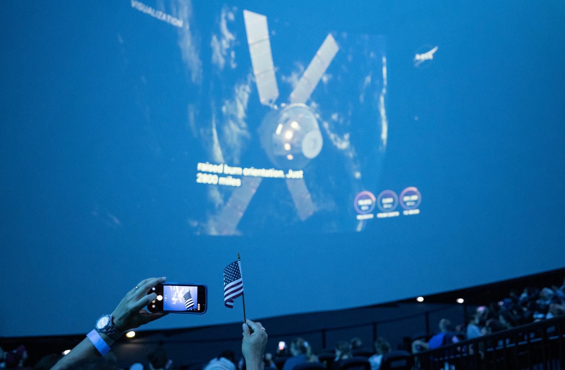 Guests at the Fleet Science Center in San Diego, California watch the live broadcast of NASA’s Orion spacecraft with Artemis II crew members NASA astronauts Reid Wiseman, commander; Victor Glover, pilot; Christina Koch, mission specialist; and CSA (Canadian Space Agency) astronaut Jeremy Hansen, mission specialist aboard landing in the Pacific Ocean off the coast of California, Friday, April 10, 2026. NASA’s Artemis II mission took Wiseman, Glover, Koch, and Hansen on a 10-day journey around the Moon and back to Earth. Photo Credit: (NASA/Keegan Barber)
