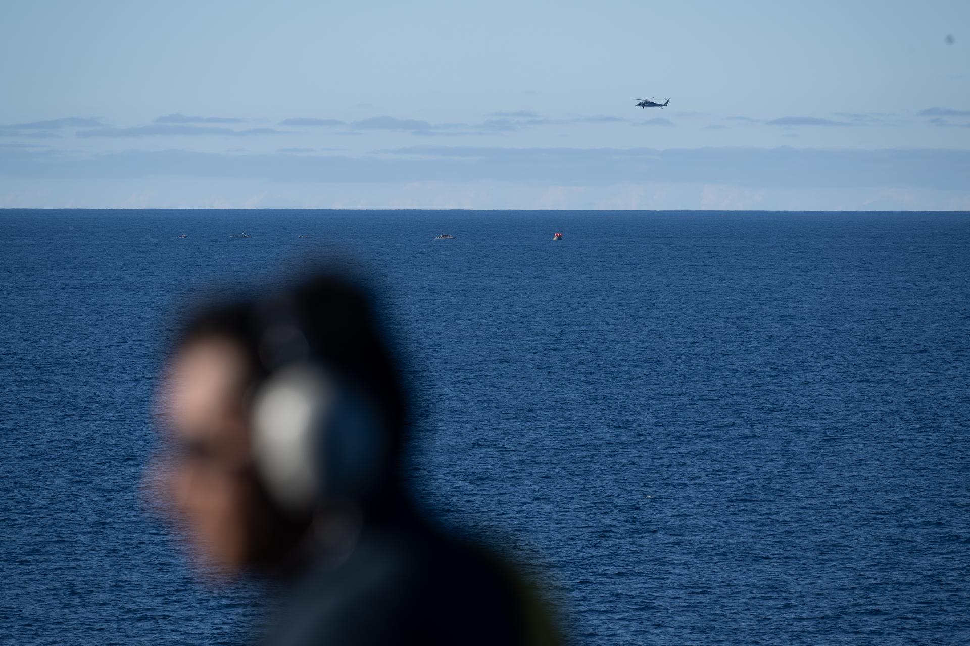 NASA’s Orion spacecraft with Artemis II crewmembers NASA astronauts Reid Wiseman, commander; Victor Glover, pilot; Christina Koch, mission specialist; and CSA (Canadian Space Agency) astronaut Jeremy Hansen, mission specialist aboard is seen after landing as recovery teams as NASA’s Landing and Recovery team, along with U.S. Navy personnel in small boats begin to approach the spacecraft in the Pacific Ocean off the coast of California, Friday, April 10, 2026. NASA’s Artemis II mission took Wiseman, Glover, Koch, and Hansen on a nearly 10-day journey around the Moon and back to Earth. Following a splashdown at 5:07 p.m. PDT (8:07 p.m. EDT), NASA and U.S. military teams are working to bring the crewmembers and Orion spacecraft aboard USS John P. Murtha.  Photo Credit: (NASA/Joel Kowsky)