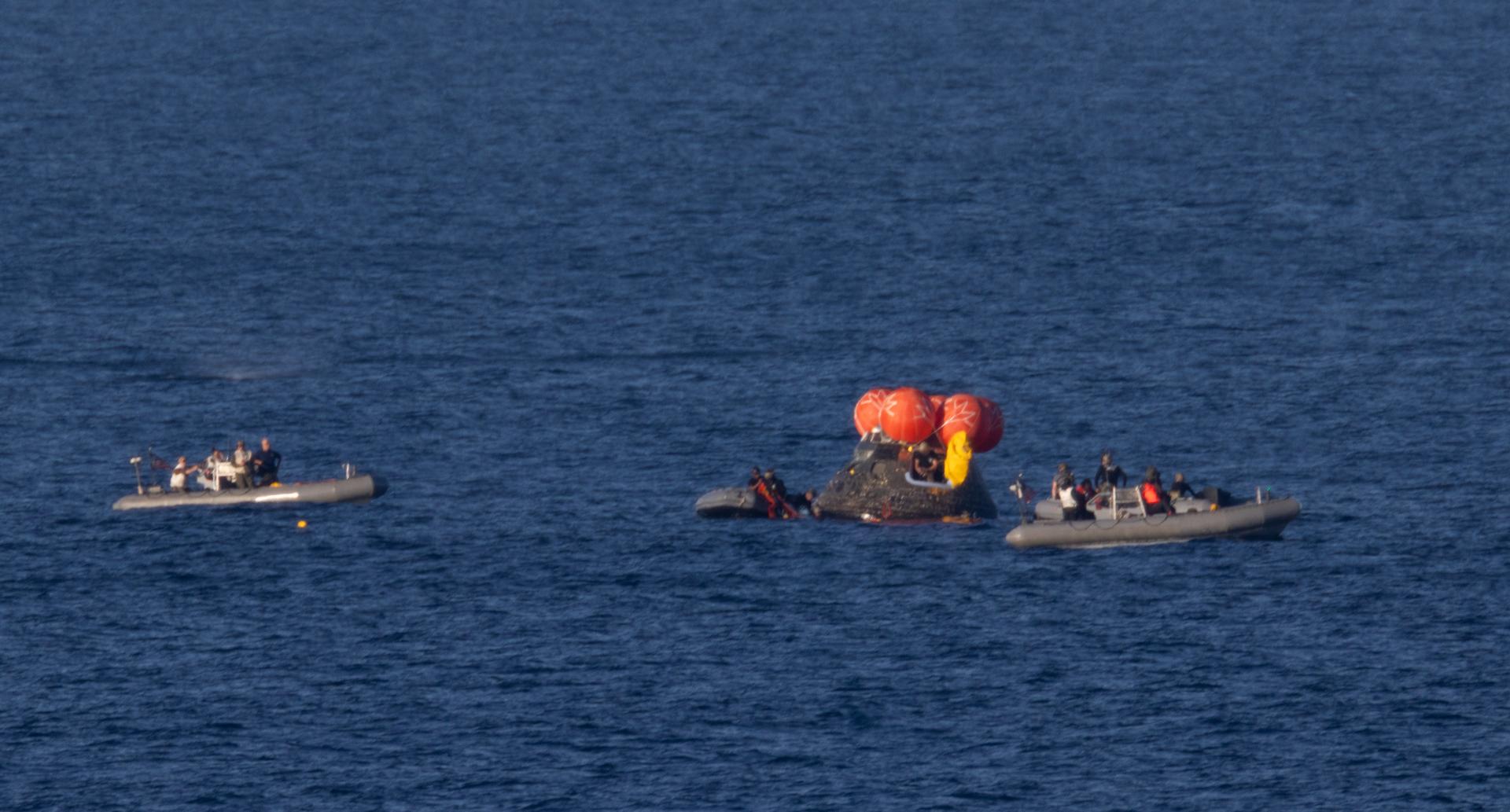 NASA’s Orion spacecraft is seen as recovery teams work to secure the spacecraft ahead of transferring Artemis II crewmembers NASA astronauts Reid Wiseman, commander; Victor Glover, pilot; Christina Koch, mission specialist; and CSA (Canadian Space Agency) astronaut Jeremy Hansen, mission specialist to USS John P. Murtha in the Pacific Ocean off the coast of California, Friday, April 10, 2026. NASA’s Artemis II mission took Wiseman, Glover, Koch, and Hansen on a nearly 10-day journey around the Moon and back to Earth. Following a splashdown at 5:07 p.m. PDT(8:07 p.m. EDT), NASA, U.S. Navy, and U.S. Air Force teams are working to bring the crewmembers and Orion spacecraft aboard USS John P. Murtha.  Photo Credit: (NASA/Joel Kowsky)