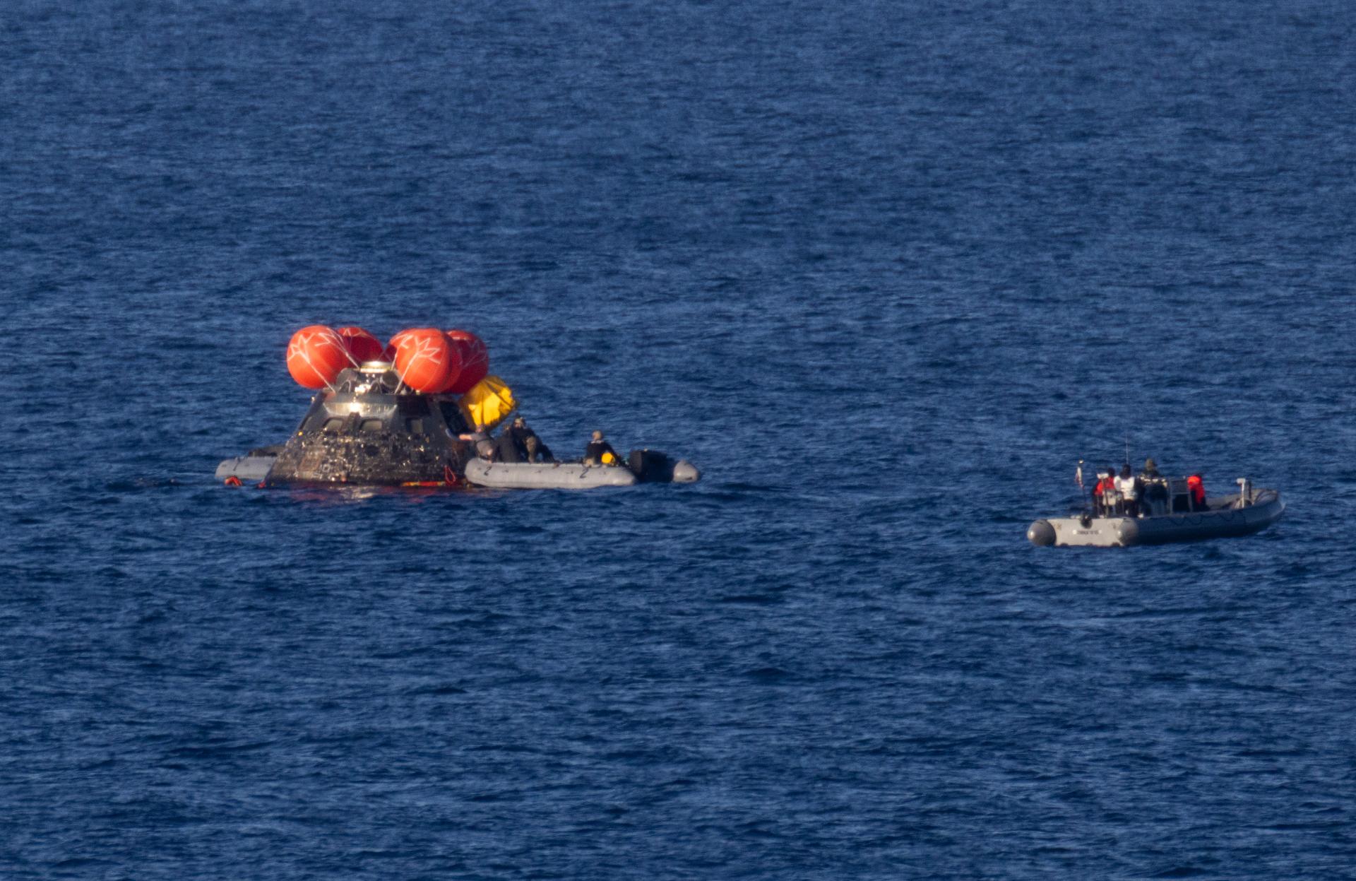 NASA’s Orion spacecraft is seen as recovery teams work to secure the spacecraft ahead of transferring Artemis II crewmembers NASA astronauts Reid Wiseman, commander; Victor Glover, pilot; Christina Koch, mission specialist; and CSA (Canadian Space Agency) astronaut Jeremy Hansen, mission specialist to USS John P. Murtha in the Pacific Ocean off the coast of California, Friday, April 10, 2026. NASA’s Artemis II mission took Wiseman, Glover, Koch, and Hansen on a nearly 10-day journey around the Moon and back to Earth. Following a splashdown at 5:07 p.m. PDT(8:07 p.m. EDT), NASA, U.S. Navy, and U.S. Air Force teams are working to bring the crewmembers and Orion spacecraft aboard USS John P. Murtha.  Photo Credit: (NASA/Joel Kowsky)