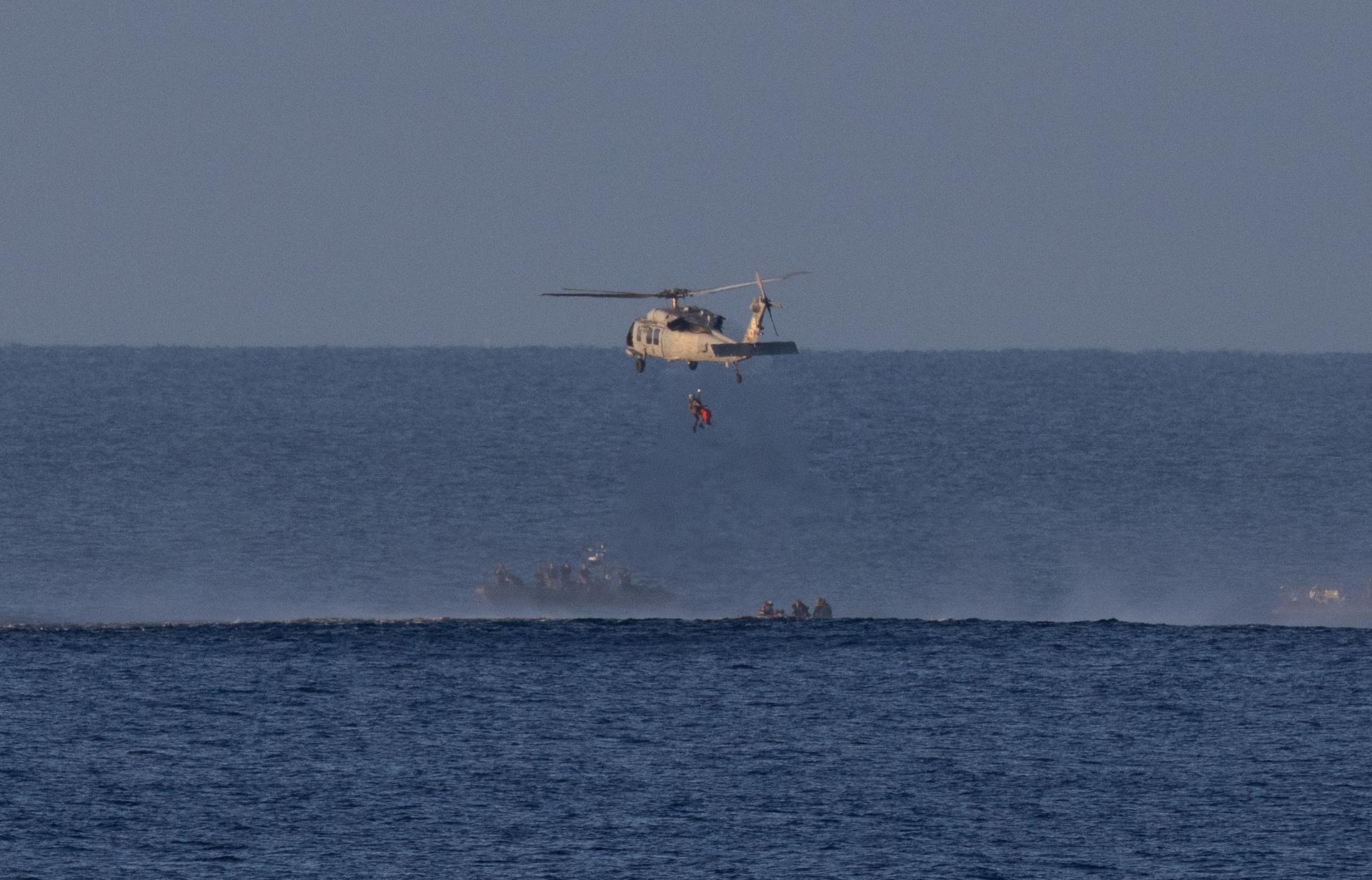 A Navy MH-60 Seahawk from Helicopter Sea Combat Squadron (HSC) 23 is seen as it lifts CSA (Canadian Space Agency) astronaut Jeremy Hansen, Artemis II mission specialist as teams work to bring the crewmembers aboard USS John P. Murtha, Friday, April 10, 2026, in the Pacific Ocean off the coast of California. NASA’s Artemis II mission took Hansen, NASA astronauts Reid Wiseman, commander; Victor Glover, pilot; and Christina Koch, mission specialist on a nearly 10-day journey around the Moon and back to Earth. Following a splashdown at 5:07 p.m. PDT (8:07 p.m. EDT), NASA, U.S. Navy, and U.S. Air Force teams are working to bring the crewmembers and Orion spacecraft aboard the recovery ship. Photo Credit: (NASA/Joel Kowsky)